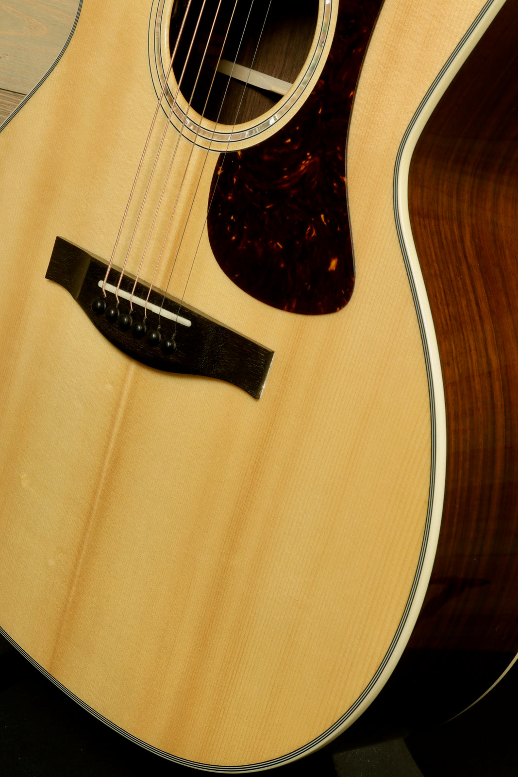 Close-up of Eastman AC422CE Grand Auditorium Cutaway Acoustic Electric Guitar with fine wood grain