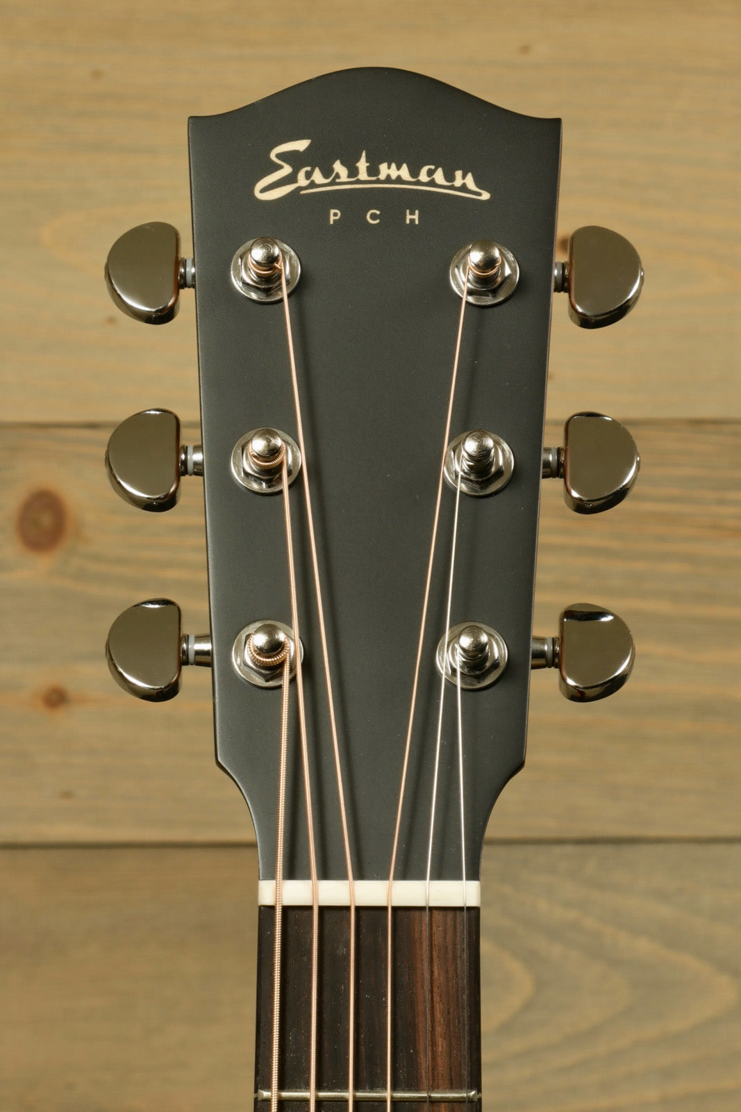 Eastman PCH acoustic guitar headstock in black with chrome tuning pegs, front view