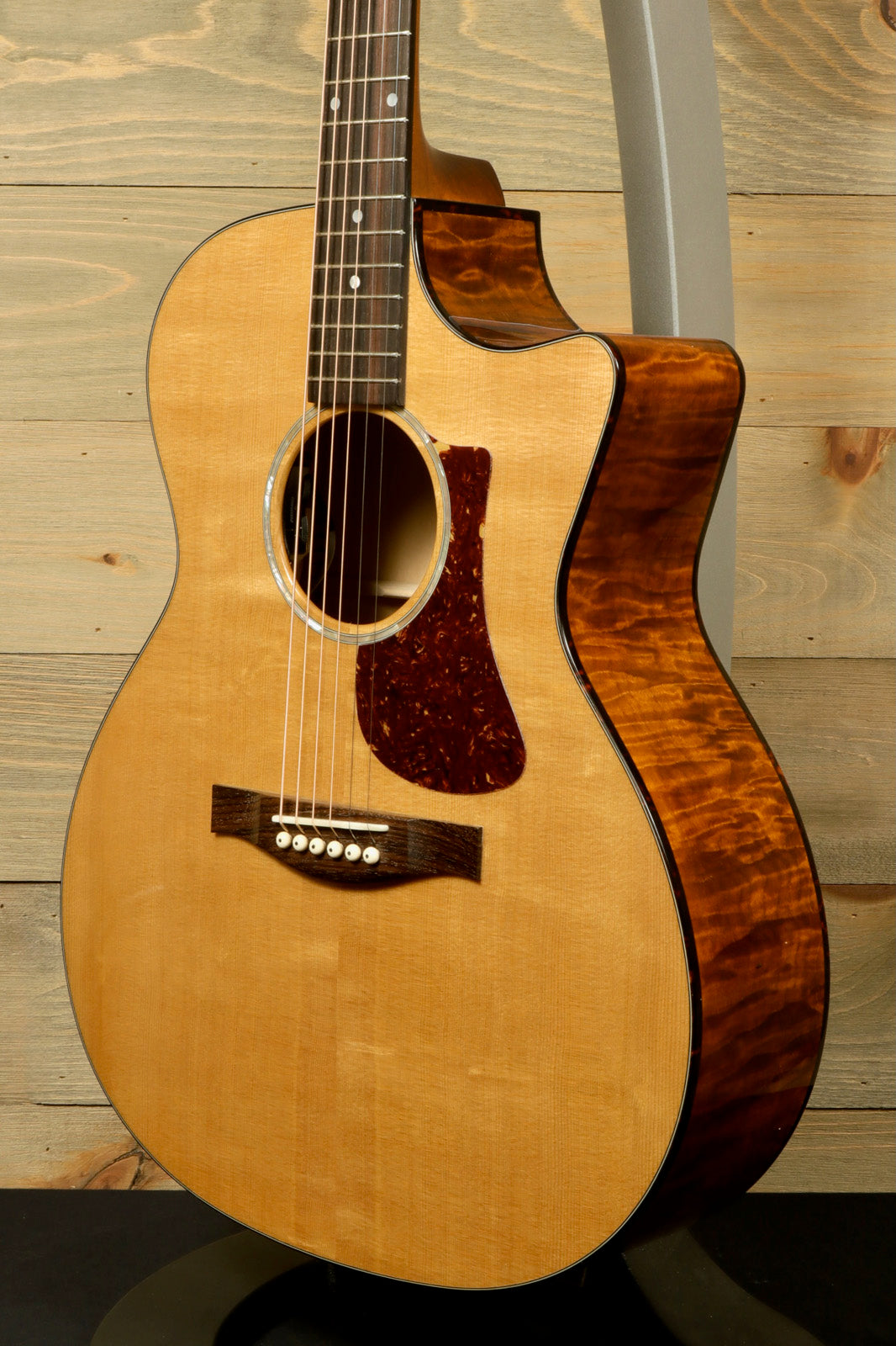 Eastman acoustic guitar with natural finish and elegant body shape, shown from the front angle.