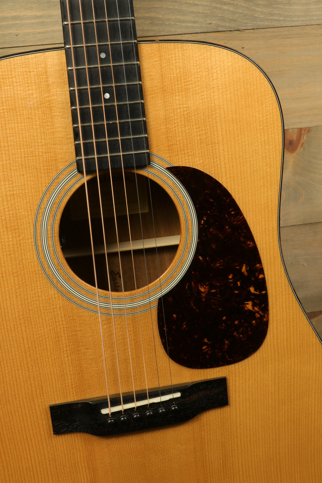Eastman E10D-TC acoustic electric guitar with natural finish, close-up view of the body and soundhole