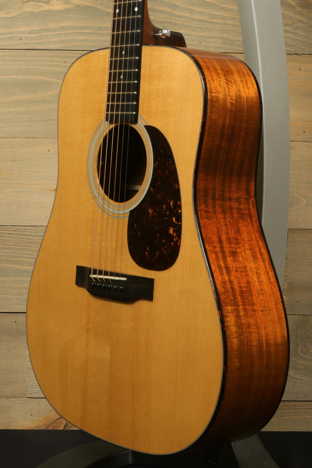 Eastman E10D-TC acoustic electric guitar with natural finish and elegant wooden accents, front view