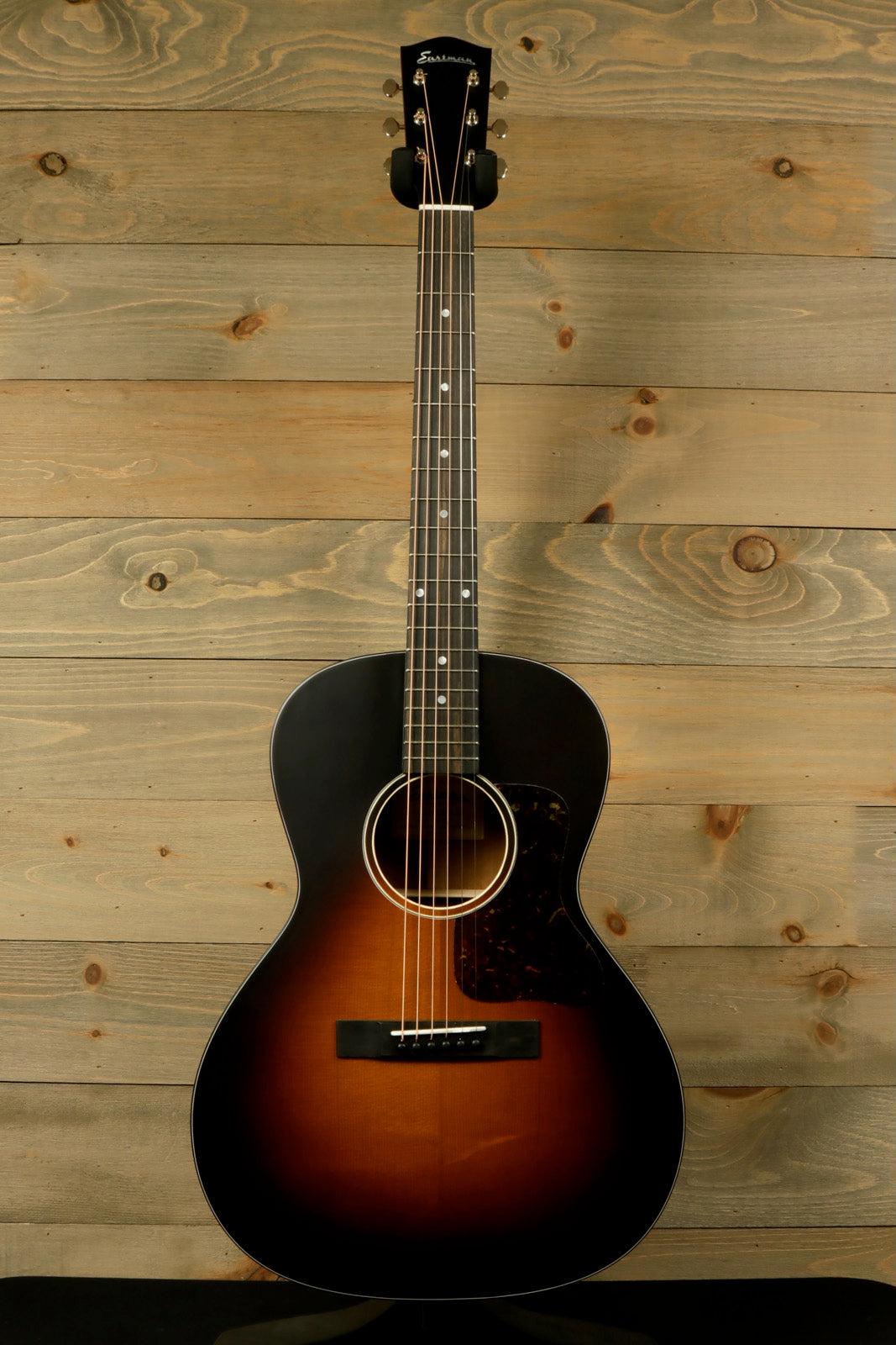 Eastman E10OOSS/v Classic Acoustic with Aged Look and Played In Feel displayed against a wooden background