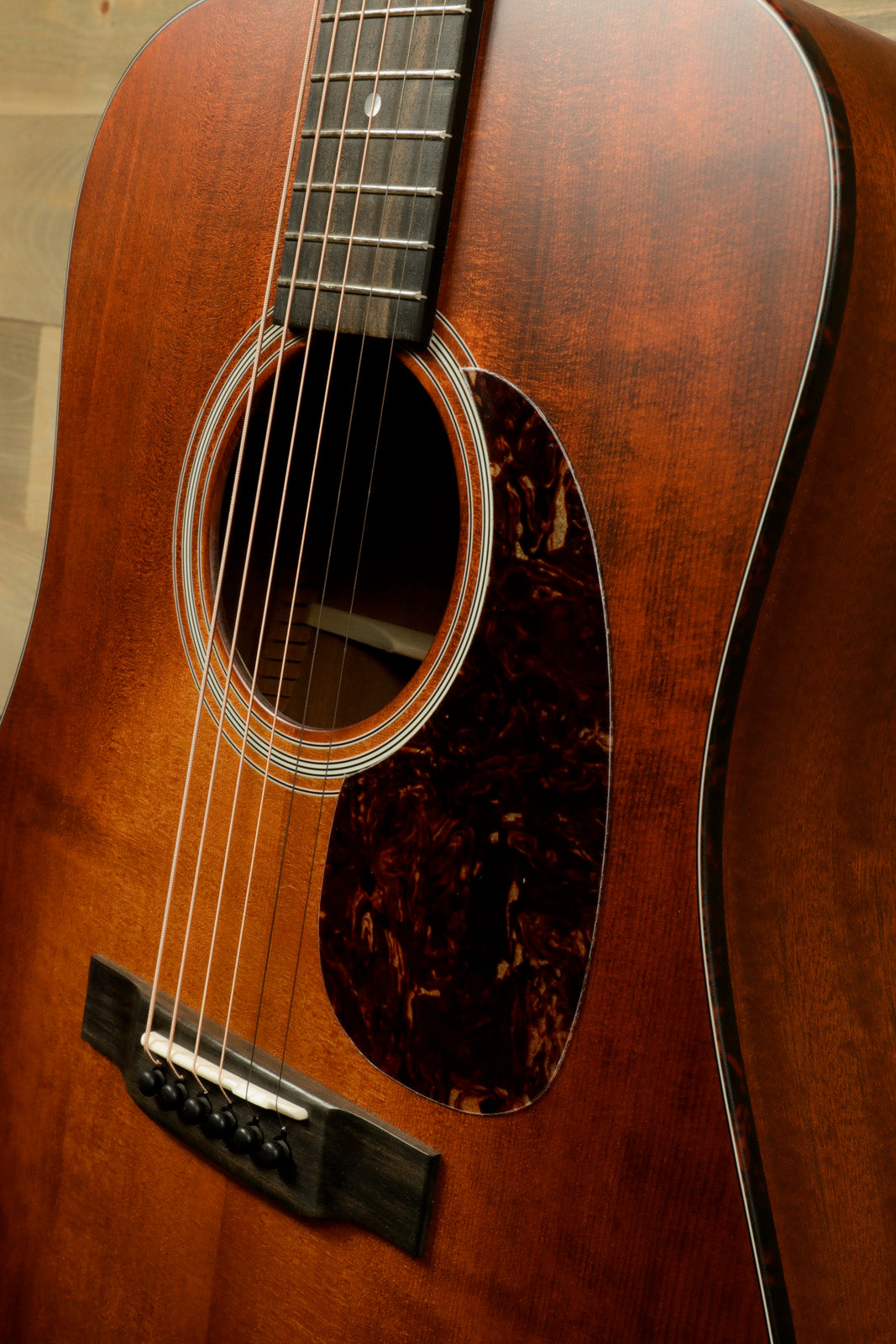 Eastman E1D-CLA acoustic guitar with a classic finish, featuring a stylish pickguard and detailed neck view