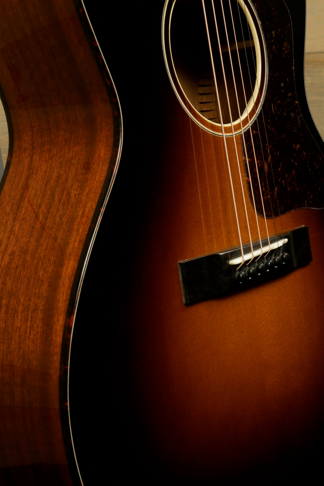 Eastman E1OOSS-DLX-SB acoustic guitar, sunburst finish, front view showcasing body and soundhole