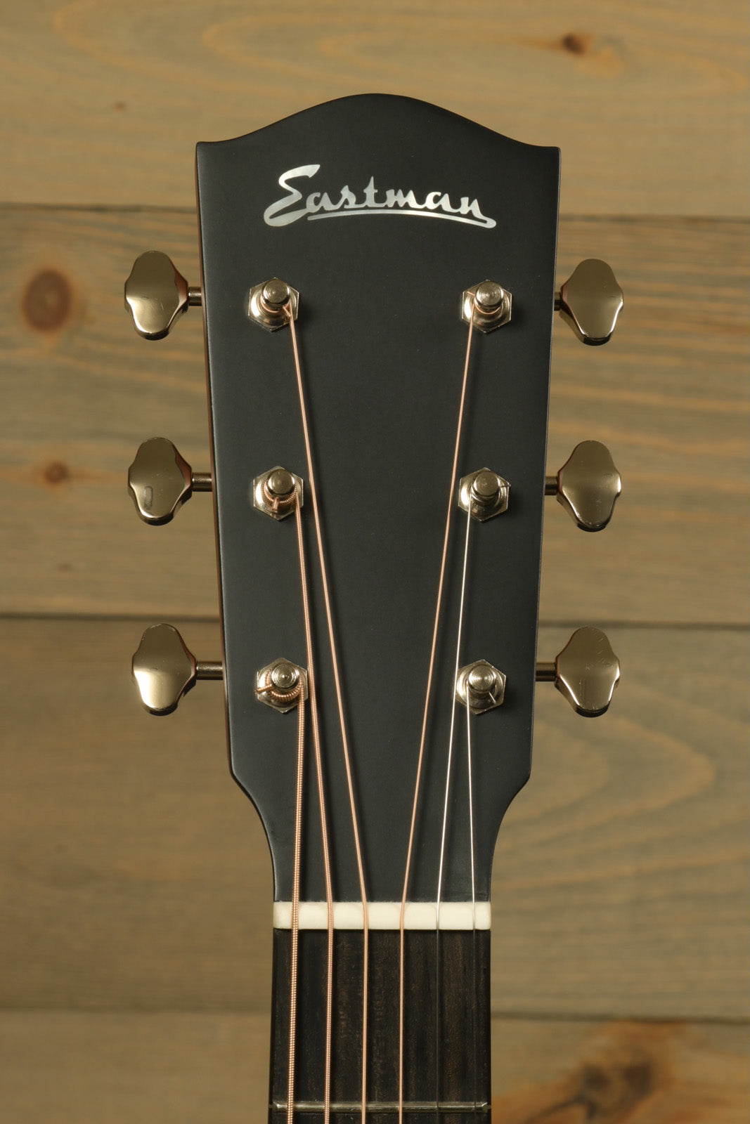 Eastman E1OOSS-DLX-SB acoustic guitar headstock, black finish with silver tuners