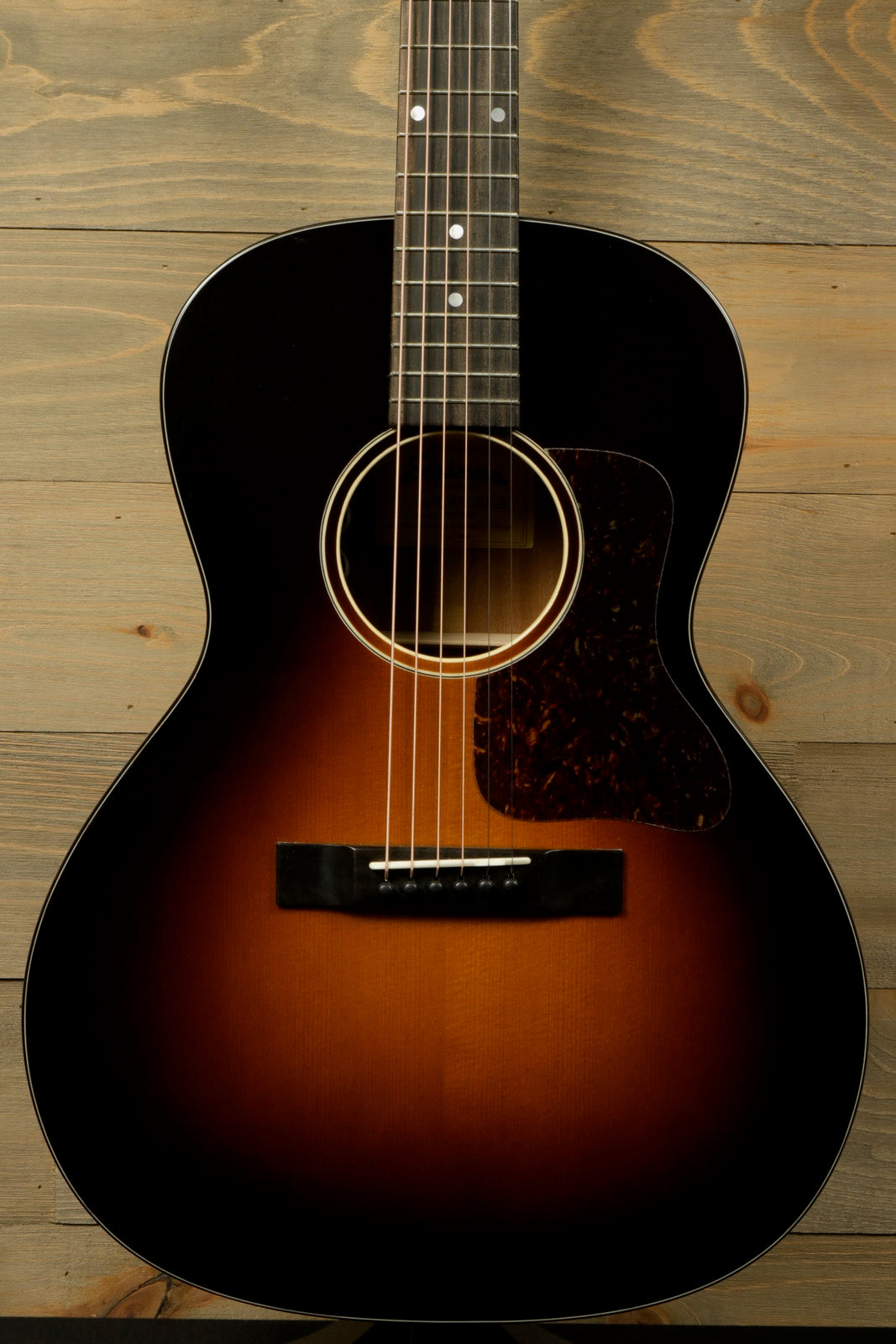 Eastman E1OOSS-DLX-SB acoustic guitar in sunburst finish, front view showcasing the body and neck