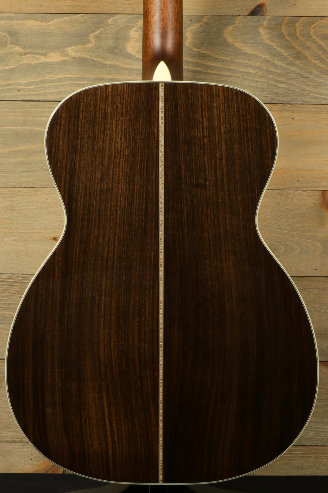 Back view of Eastman E8OM-TC acoustic guitar showcasing rich mahogany grain and elegant craftsmanship