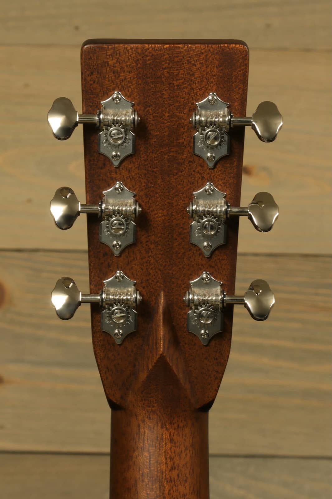 The headstock of the Eastman E8OM-TC acoustic guitar showcasing beautiful tuning pegs