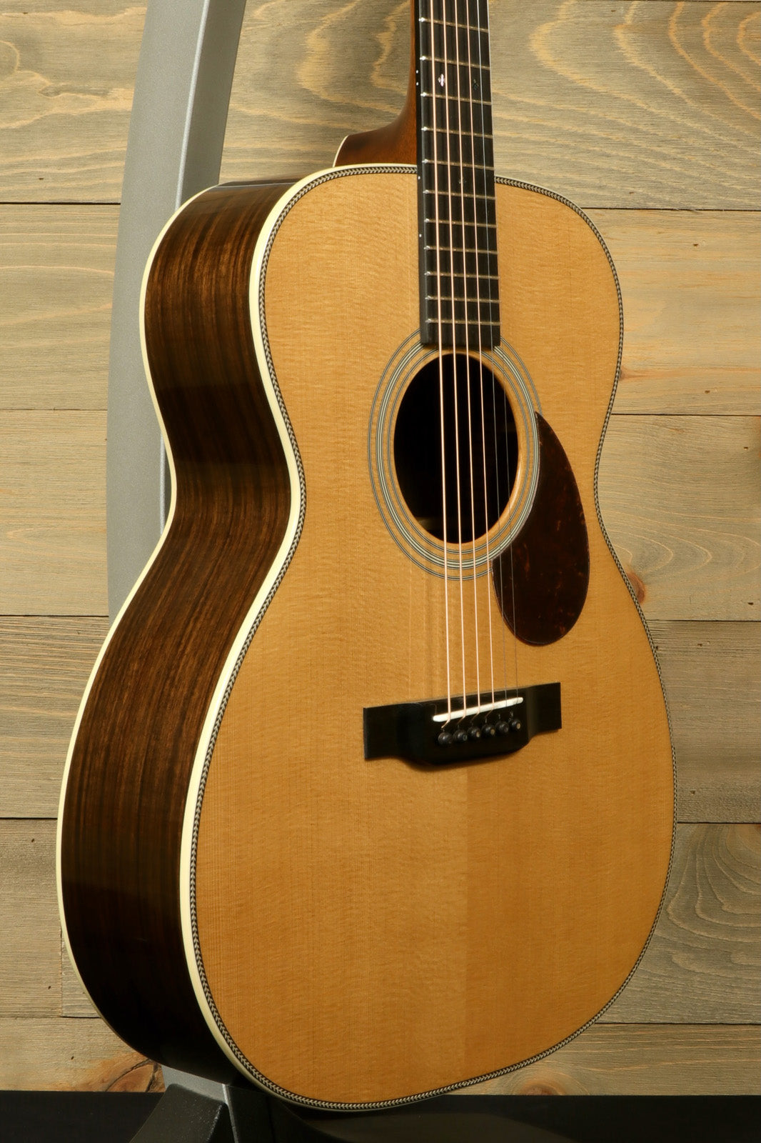 Eastman E8OM-TC acoustic guitar with natural wood finish and detailed craftsmanship