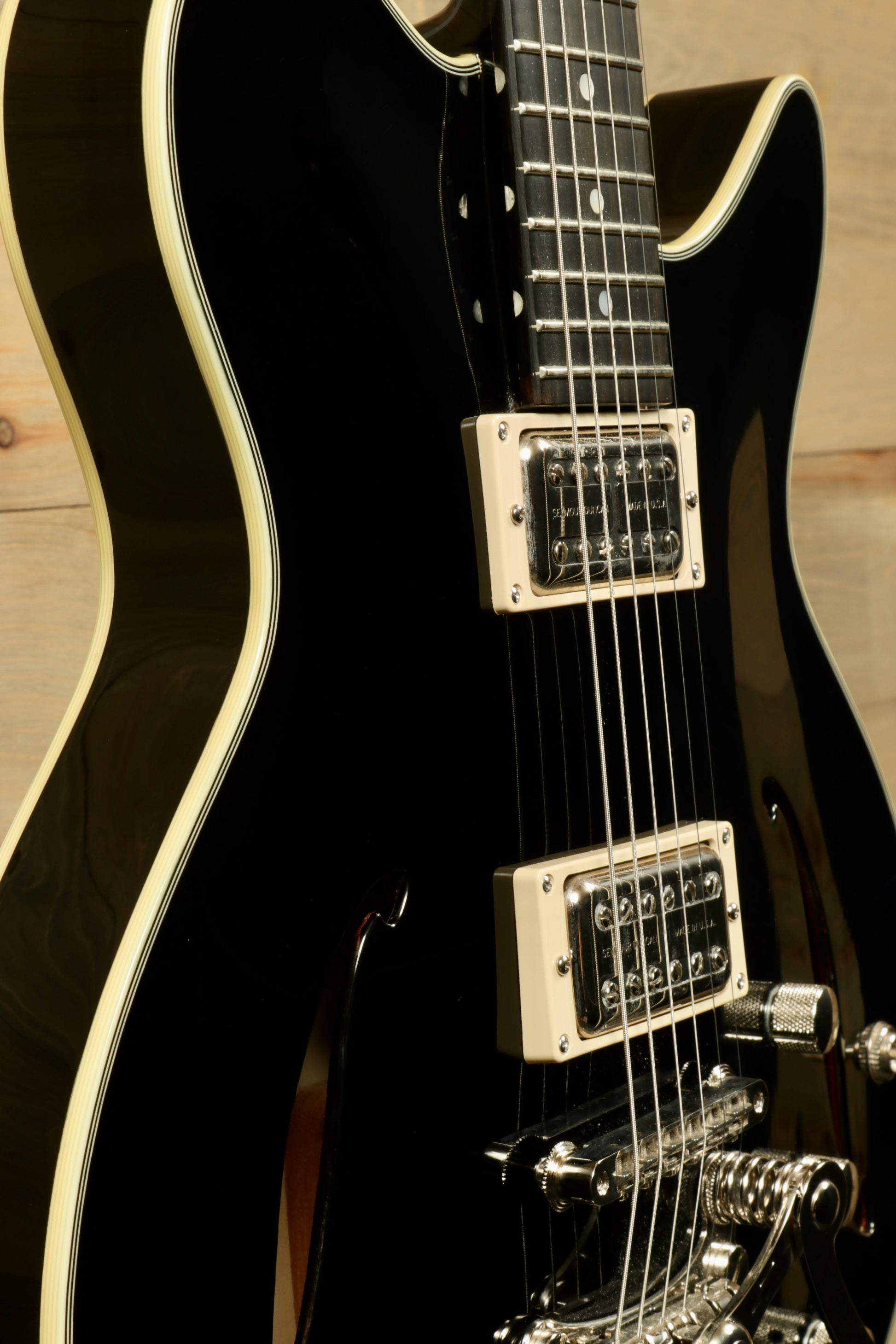 Eastman Electric Guitar with Hardshell Case, Black Finish - USED, side view showcasing its sleek design