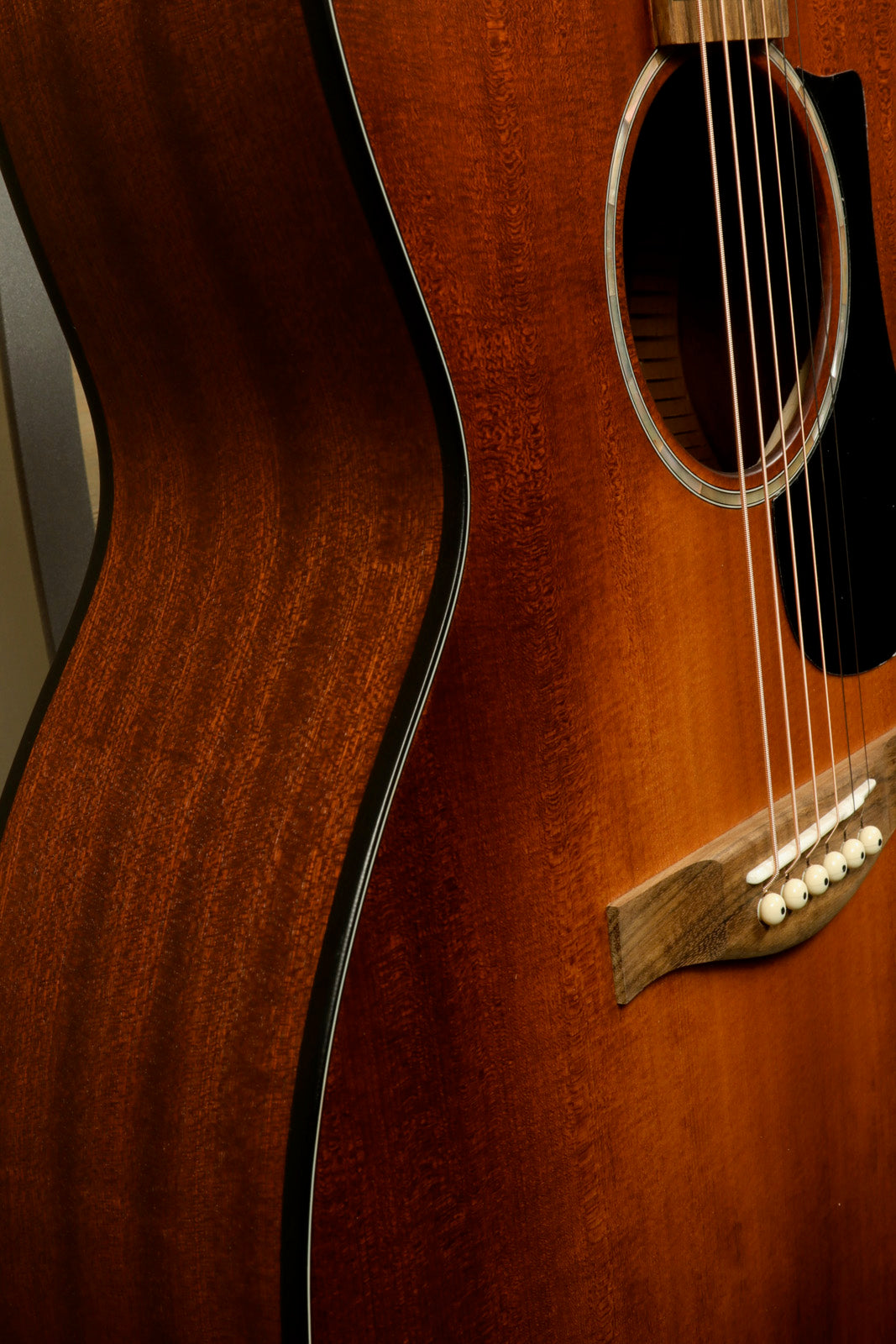 Eastman PCH1-GACE-CLA acoustic electric guitar, natural finish, side view showcasing smooth curves