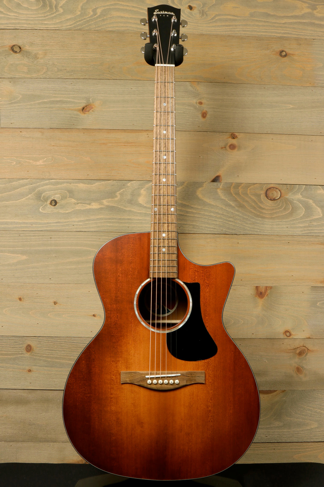 Eastman PCH1-GACE-CLA acoustic electric guitar in natural color, front view against wooden background
