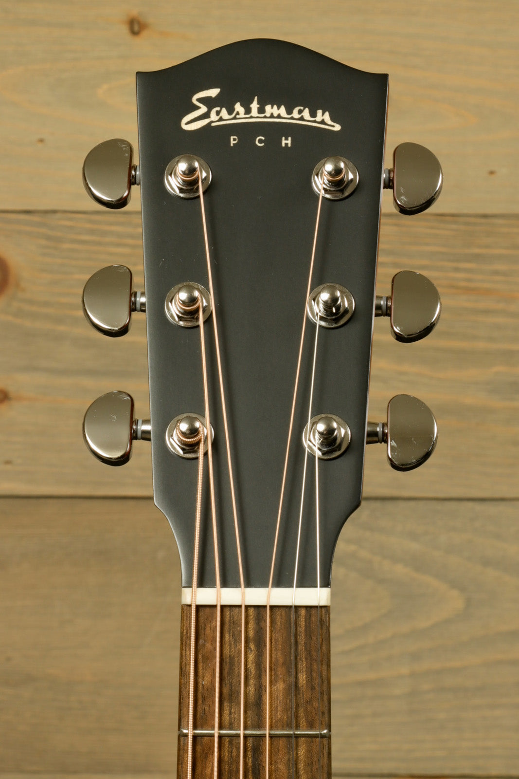 Eastman PCH1-GACE-CLA acoustic electric guitar, headstock view with chrome tuning pegs.