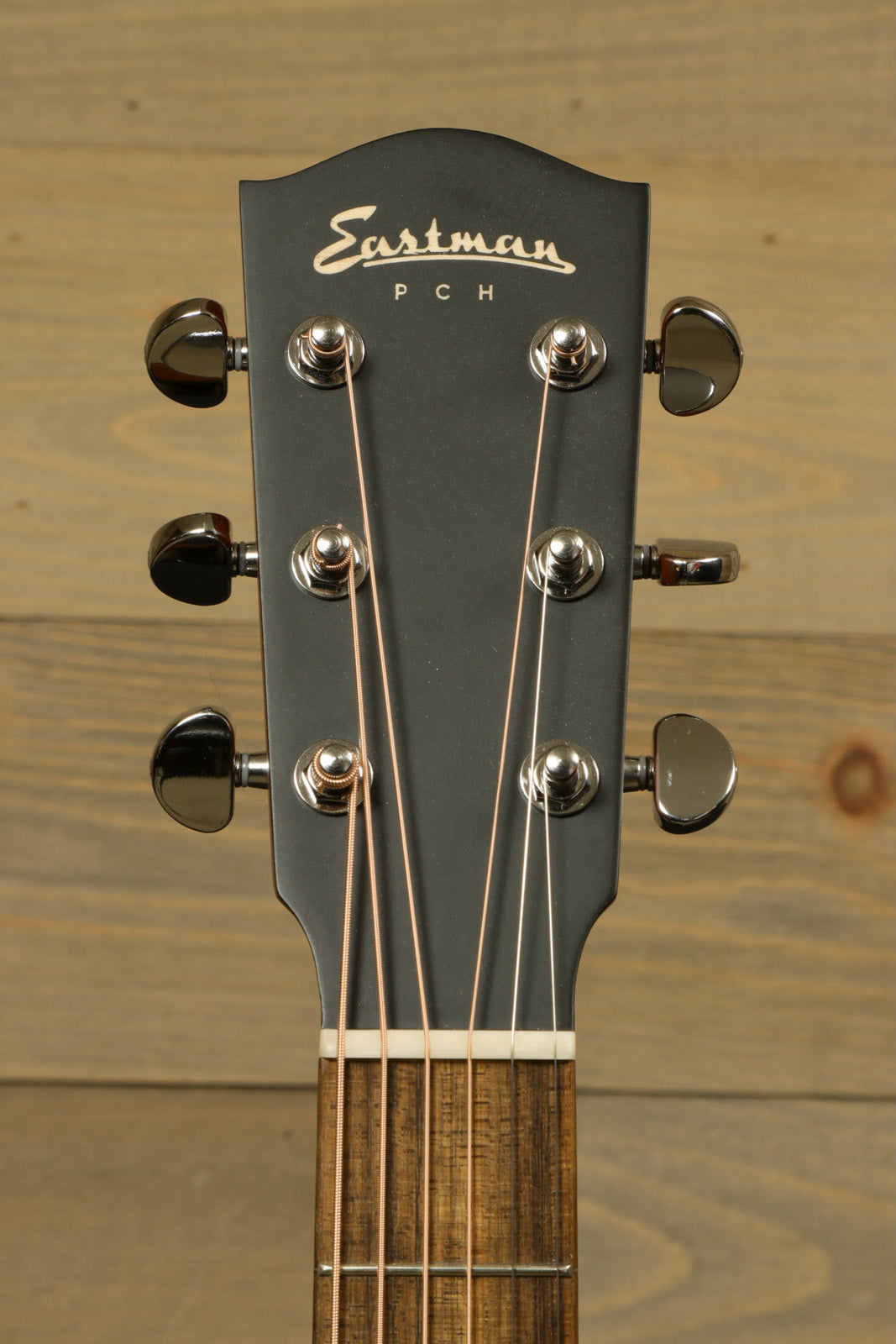 Eastman PCH1-GACE-CLA acoustic electric guitar headstock showing tuning pegs and brand logo