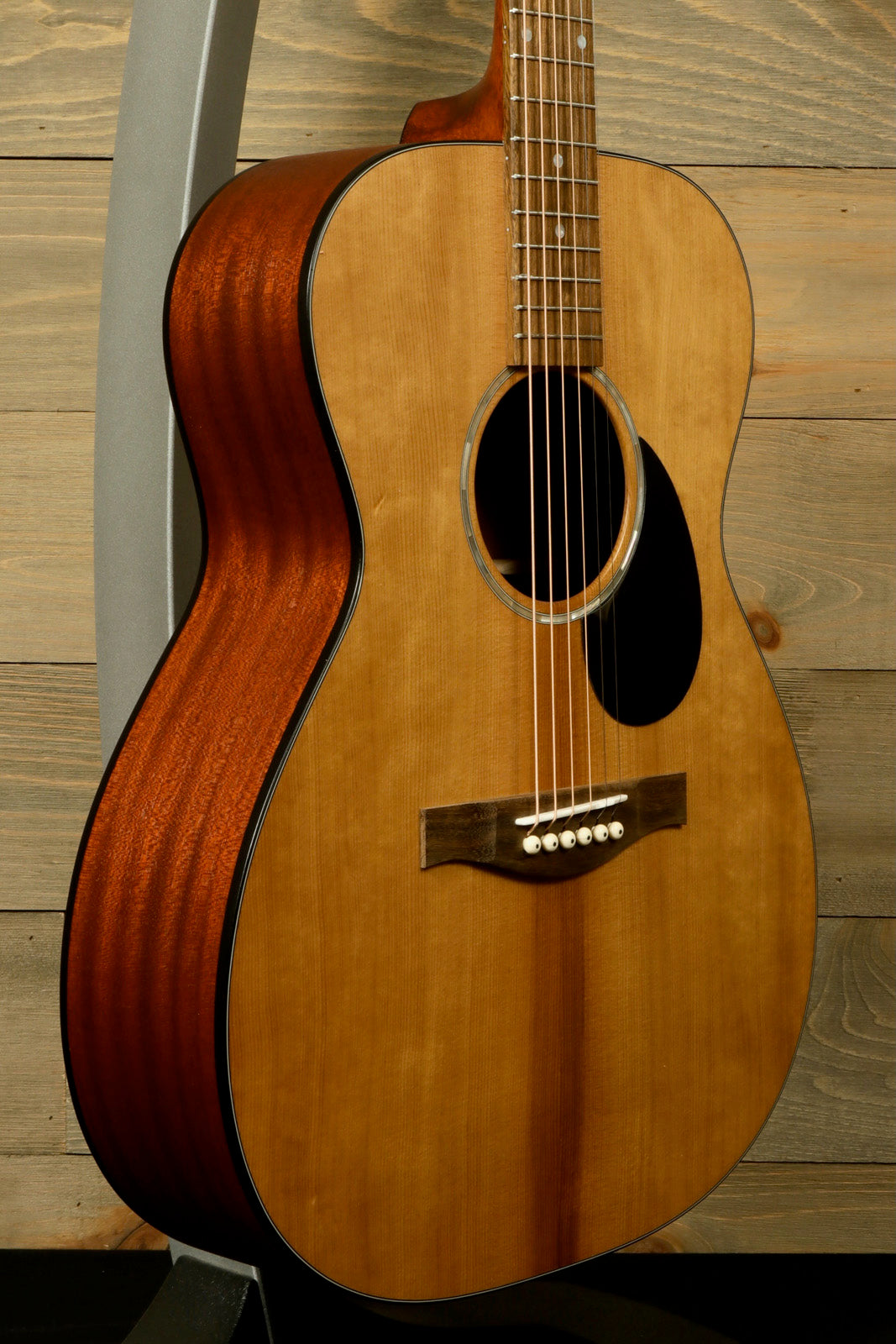 Eastman PCH1-OM acoustic guitar in natural finish, side view showcasing smooth body contour