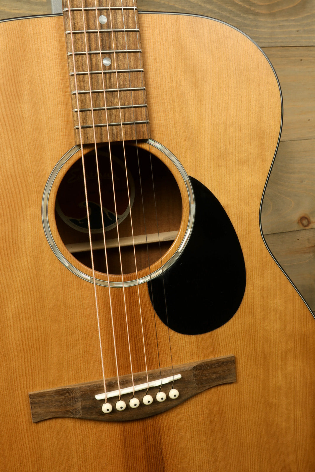 Eastman PCH1-OM acoustic guitar, natural finish, top view showcasing the body and neck