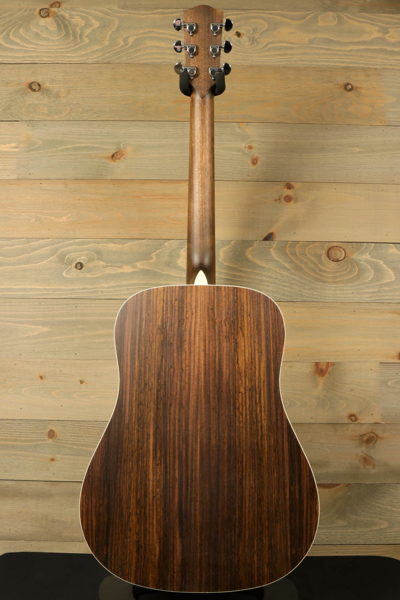 Back view of Eastman PCH2-D-BK acoustic guitar showcasing its rich wood grain and elegant design