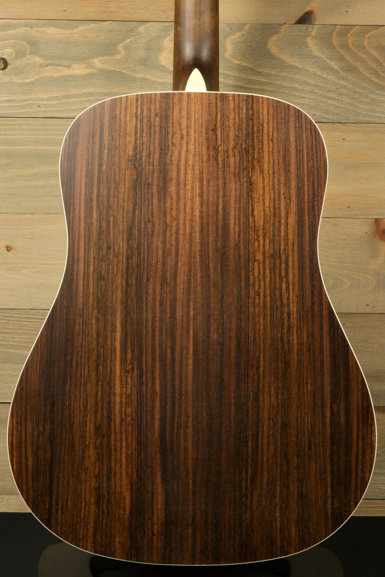 Back view of Eastman PCH2-D-BK acoustic guitar featuring a stunning wood grain finish
