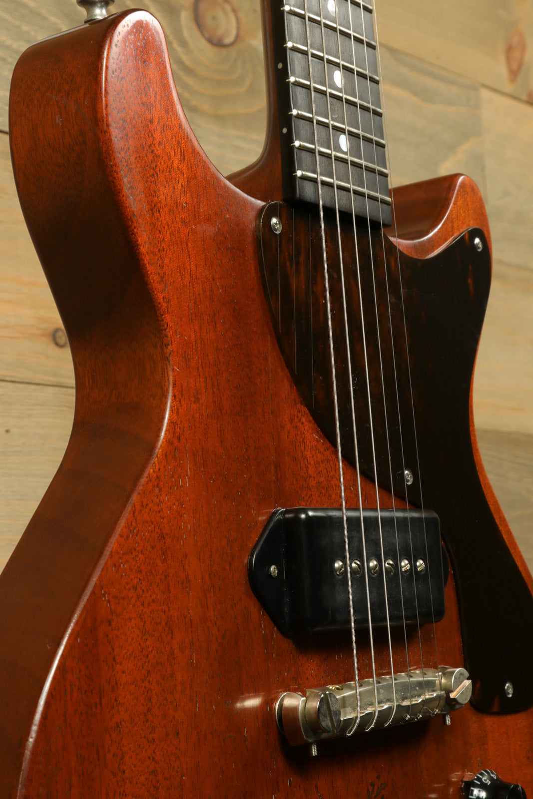 Eastman SB55DC/v electric guitar in vintage sunburst, close-up view highlighting the wood finish