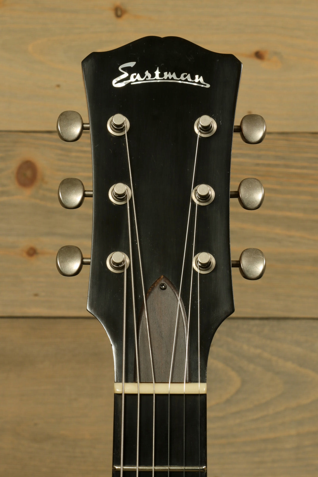 Eastman SB55DC/v electric guitar headstock in black finish, front view with tuning pegs