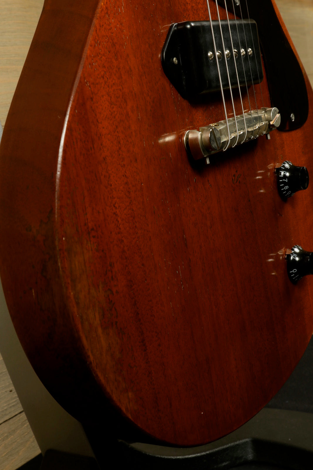 Eastman SB55DC/v mahogany electric guitar, side view showcasing smooth finish and hardware