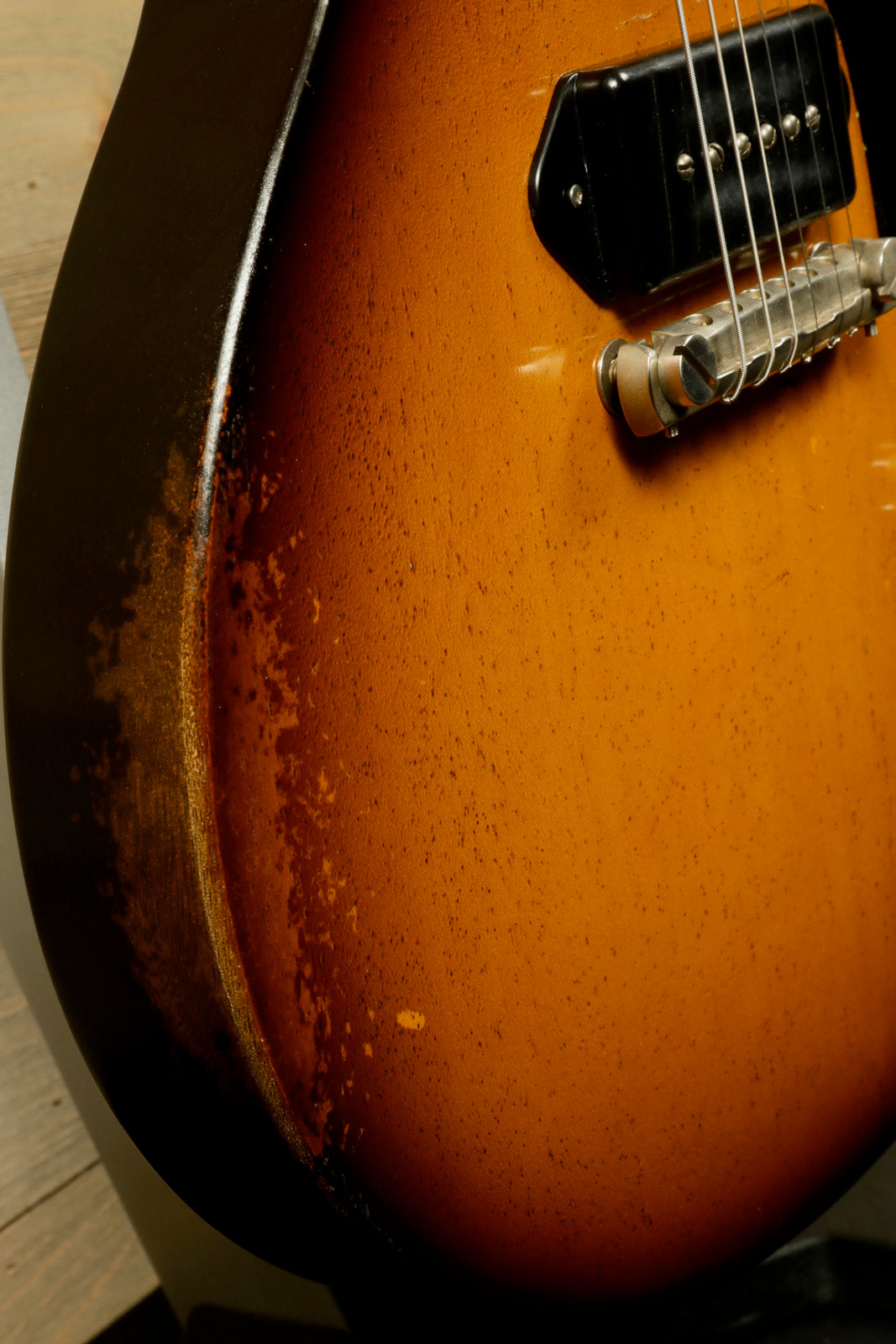 Eastman SB55/v-SB electric guitar in sunburst finish, side view showcasing vintage-style wear