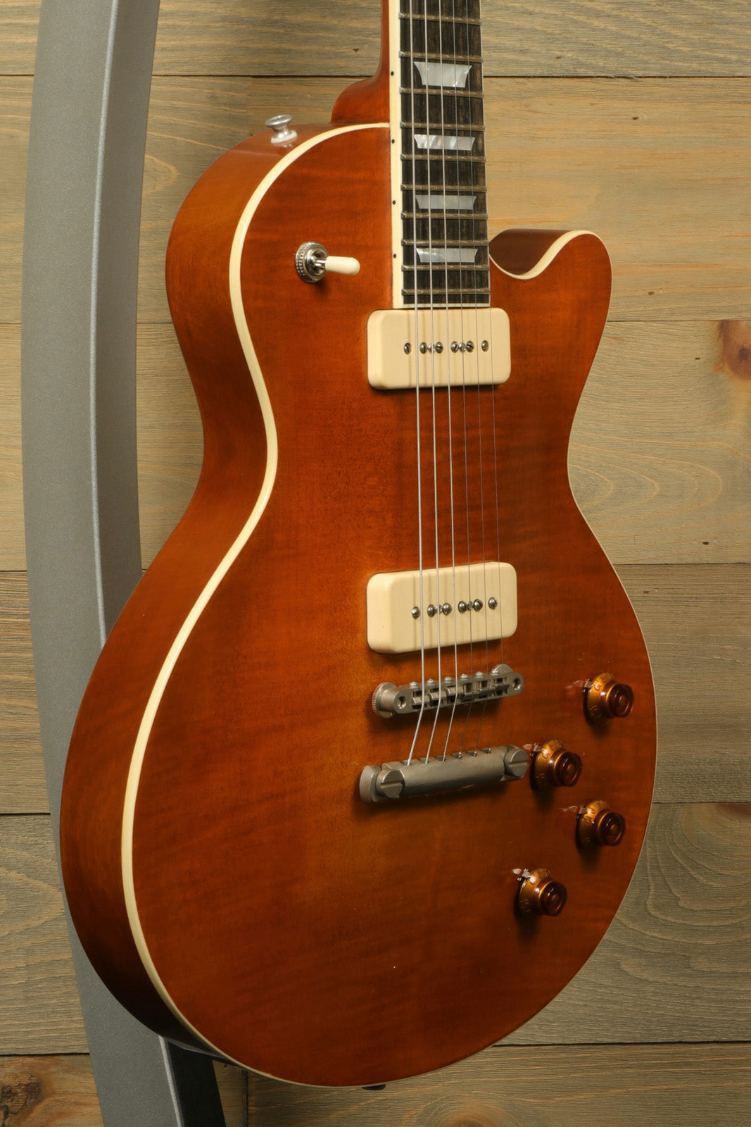 Eastman SB56/TV-AMB electric guitar in amber finish, side view showcasing body and hardware details