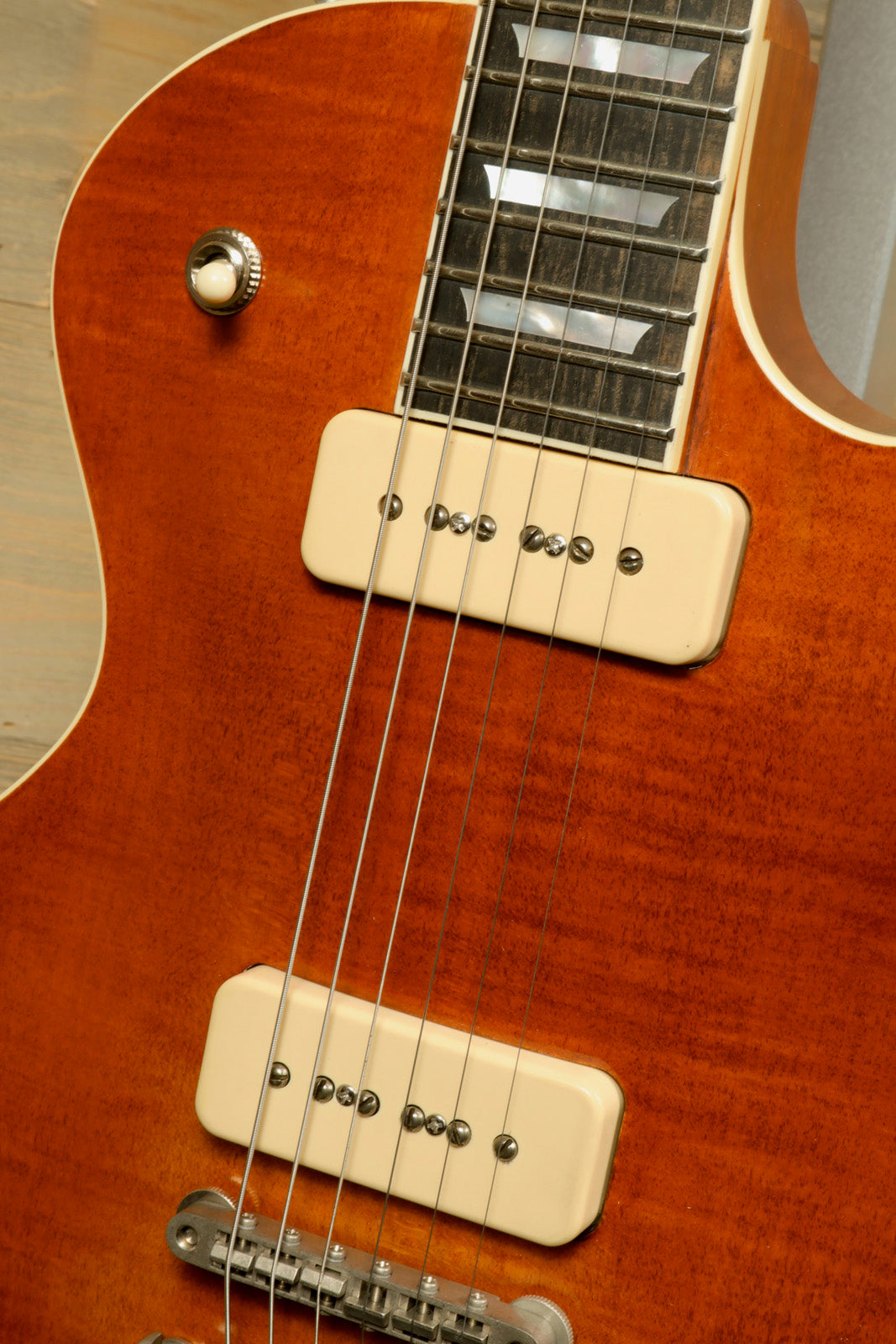 Eastman SB56/TV-AMB electric guitar in amber finish, front close-up view showcasing pickups and strings