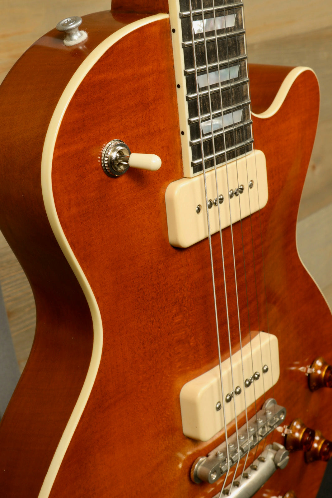 Eastman SB56/TV-AMB electric guitar in amber finish, side view showcasing body and hardware details 