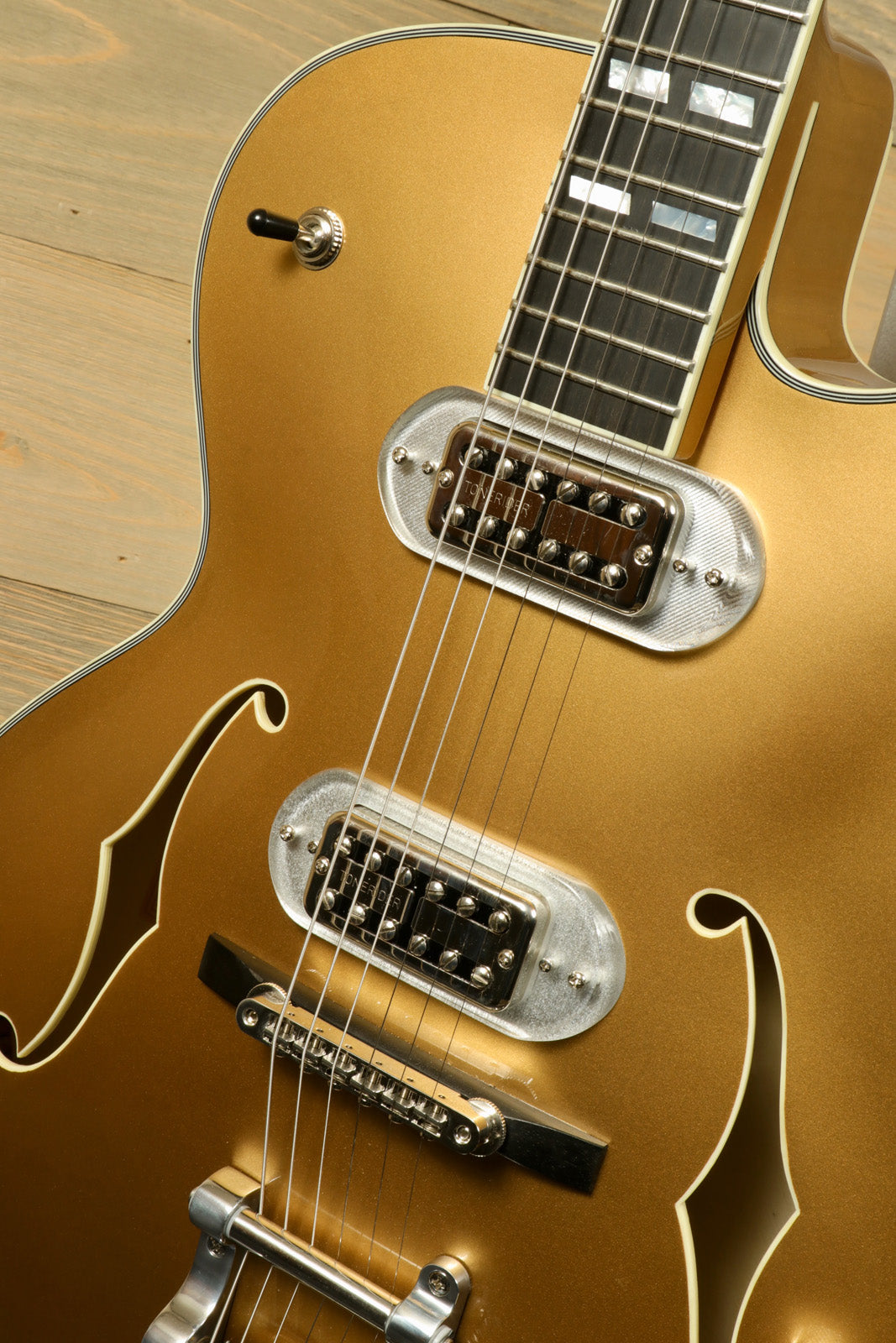 Eastman T58-GD hollow body electric guitar in gold finish, top view with pickups and controls
