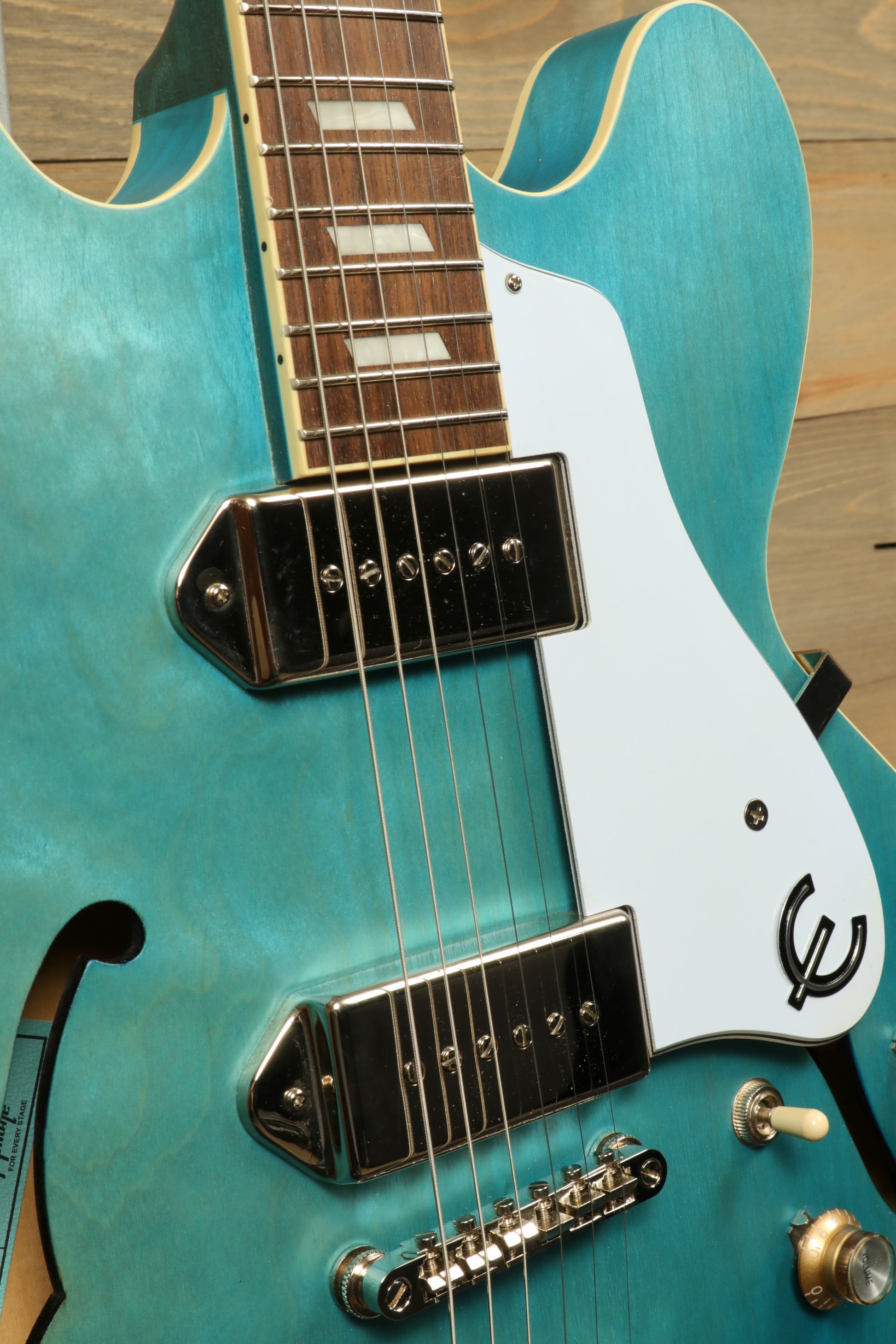 Epiphone Casino Worn hollow body electric guitar in turquoise, front view showcasing the pickups and fretboard