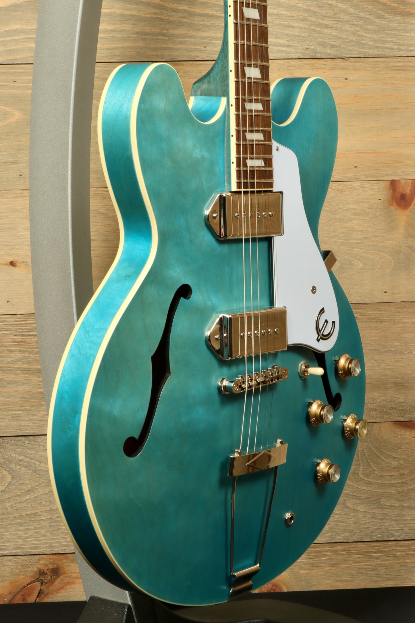 Epiphone Casino Worn hollow body electric guitar in teal, side view showcasing classic design