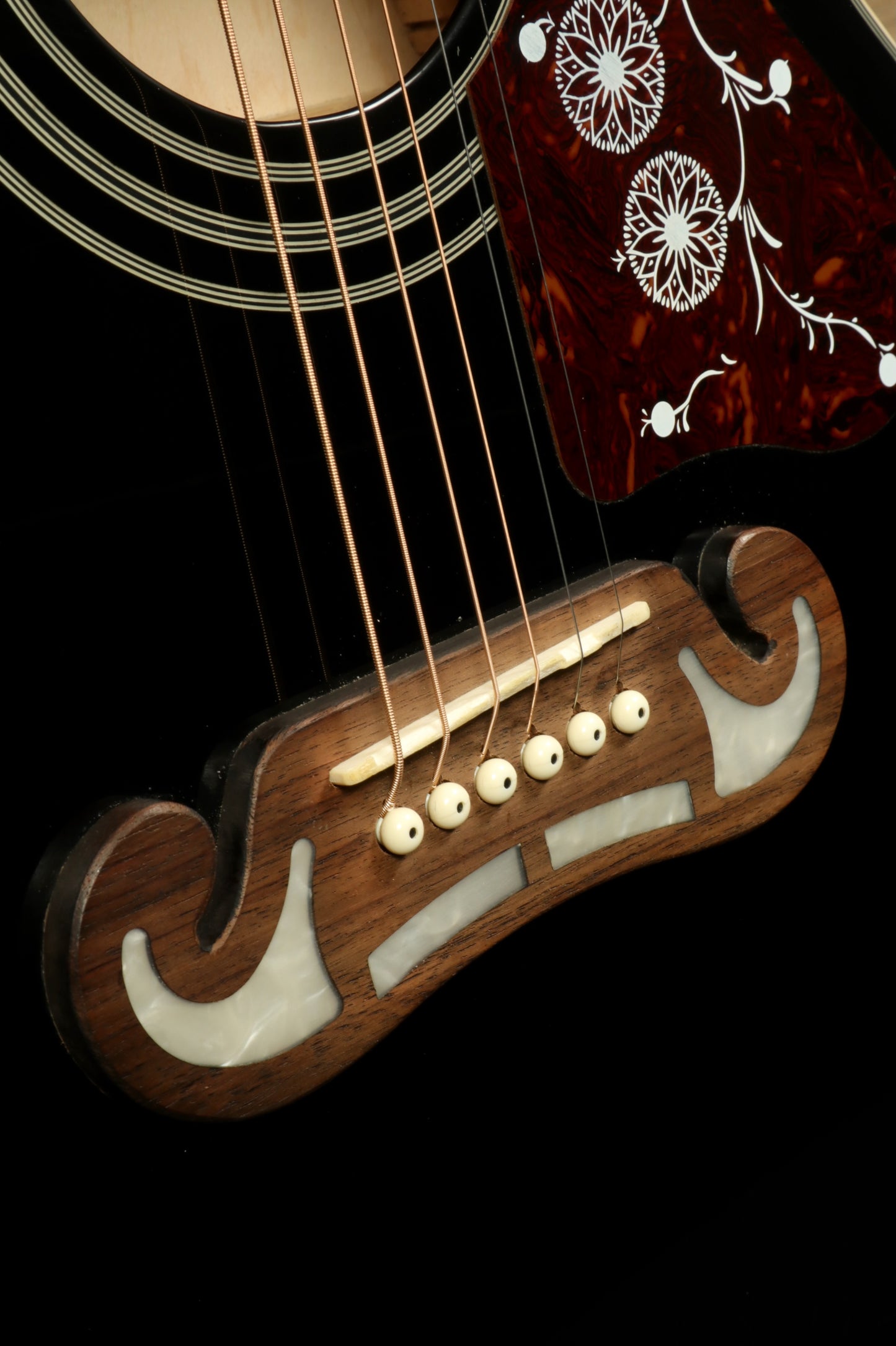 Close-up of Epiphone EJ200sce-BK USED Acoustic Electric Guitar's bridge with intricate inlays and strings