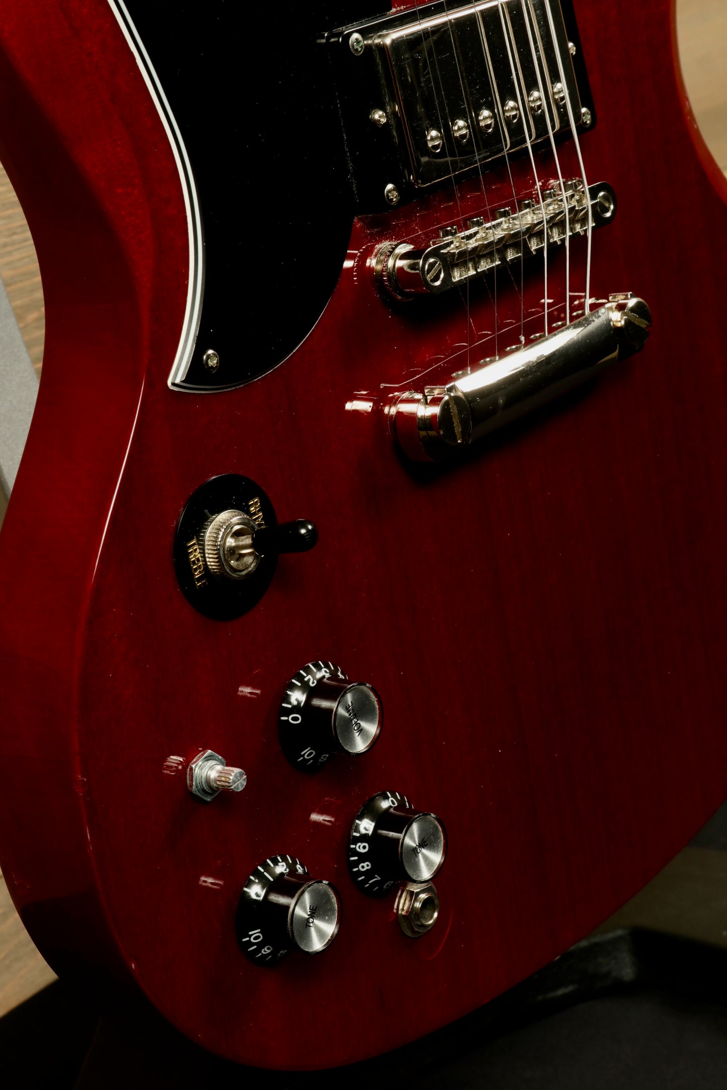 Epiphone SG Pro Left in wine red finish, featuring control knobs and pickups, side view