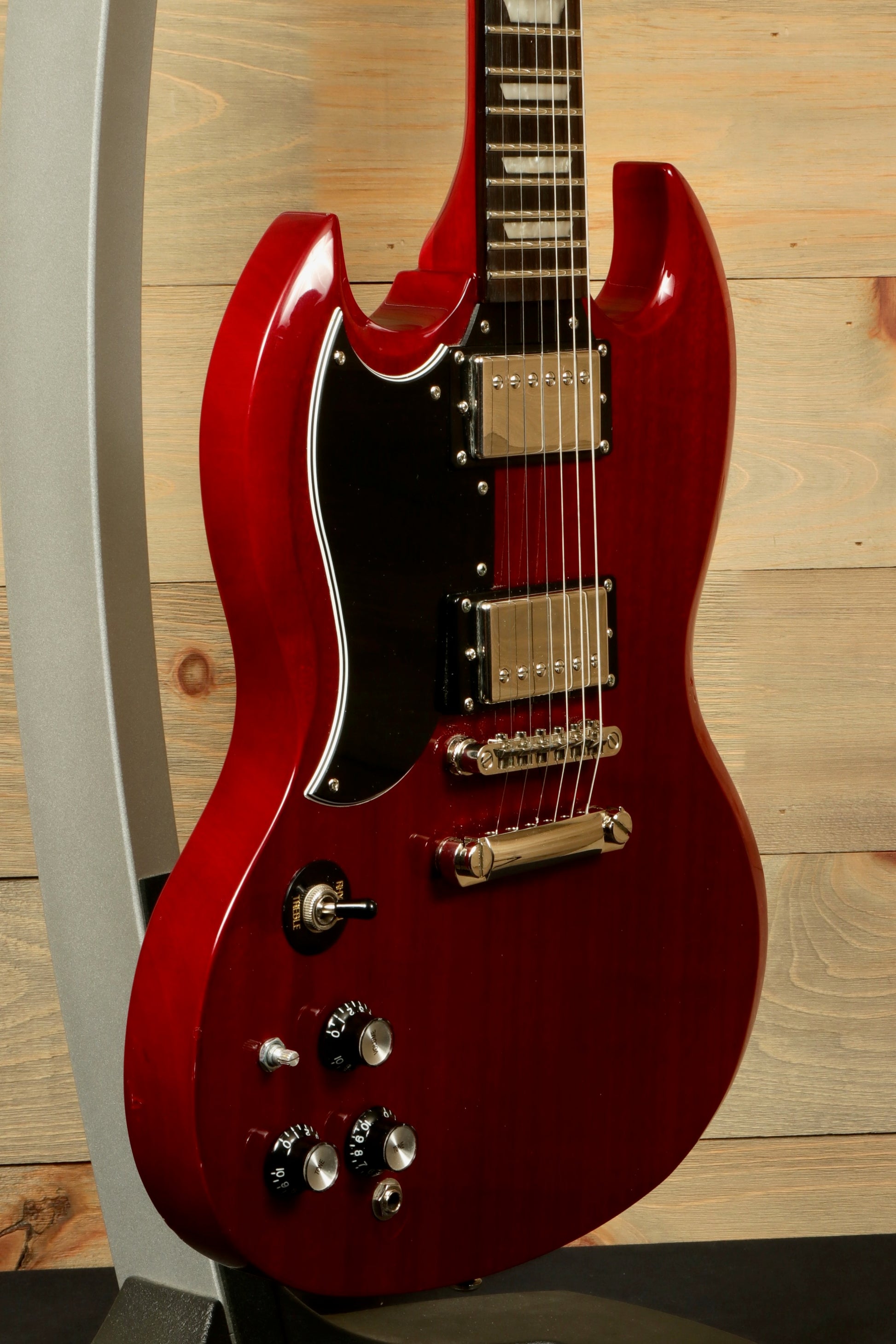 Epiphone SG Pro Left in Cherry Red, side view showcasing its sleek design and controls