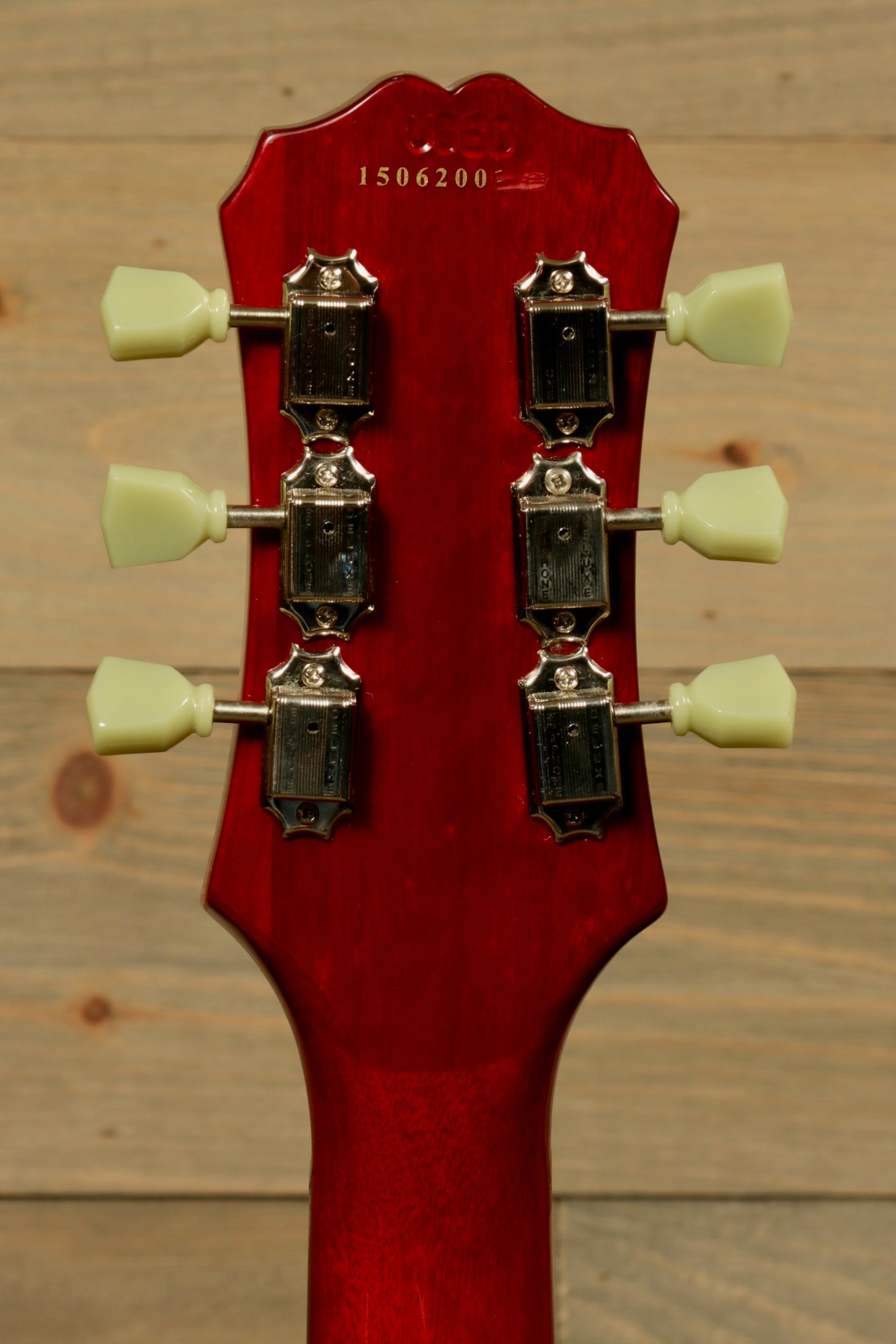 Epiphone SG Pro Left electric guitar in cherry red with classic headstock and tuning pegs, back view.