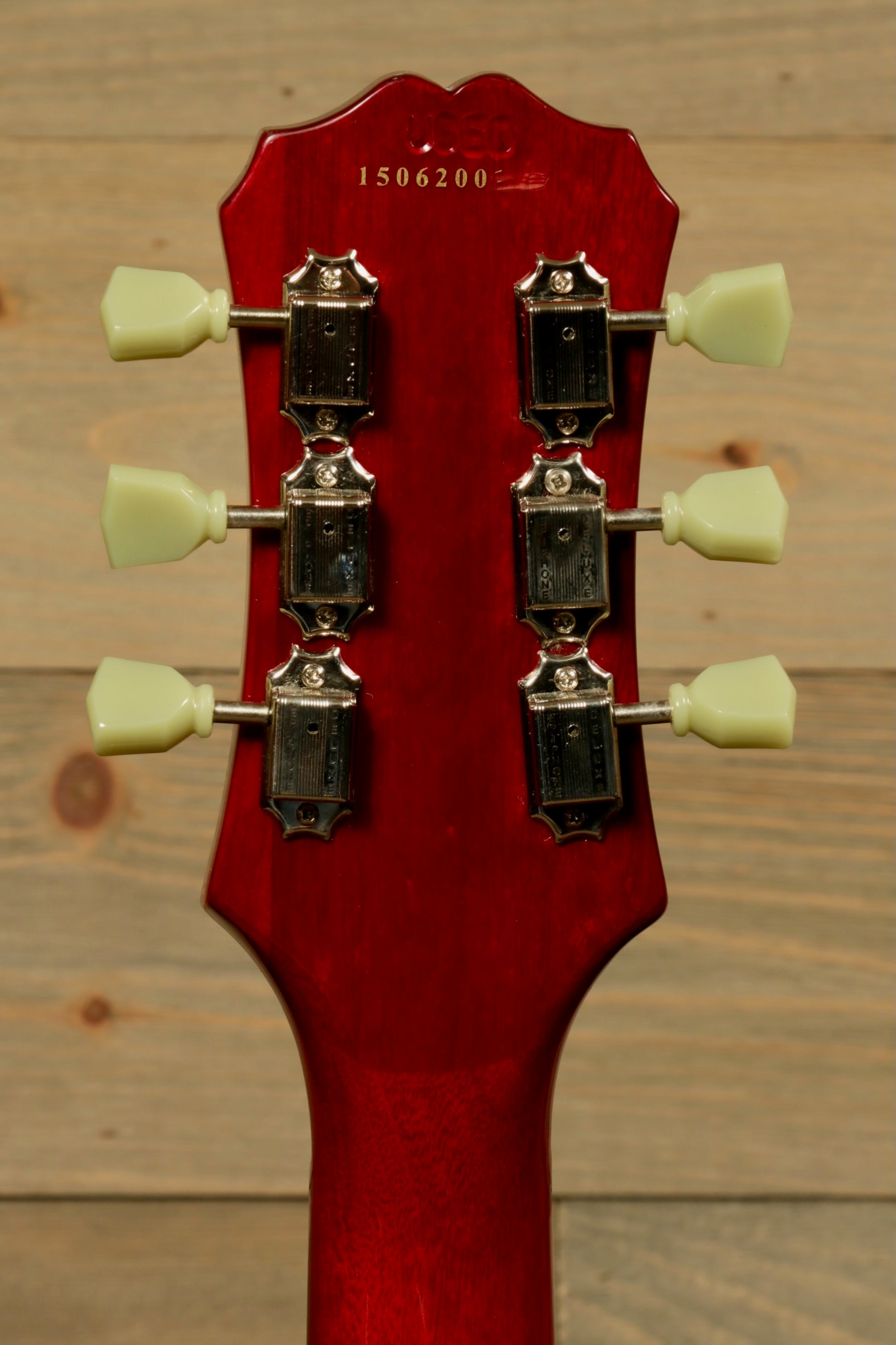Epiphone SG Pro Left electric guitar in cherry red with classic headstock and tuning pegs, back view.