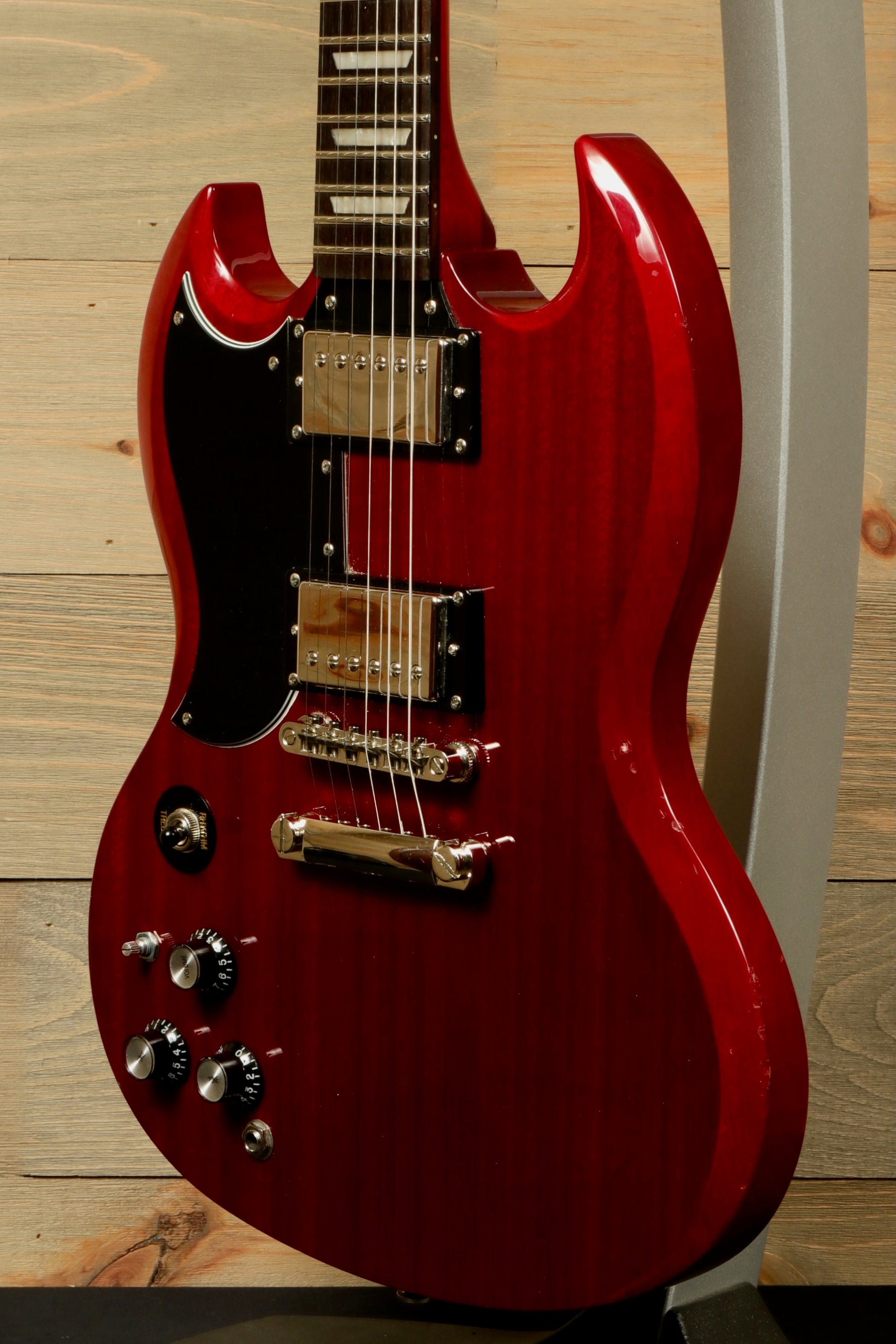 Epiphone SG Pro Left in Cherry Red, front view showcasing pickups and knobs