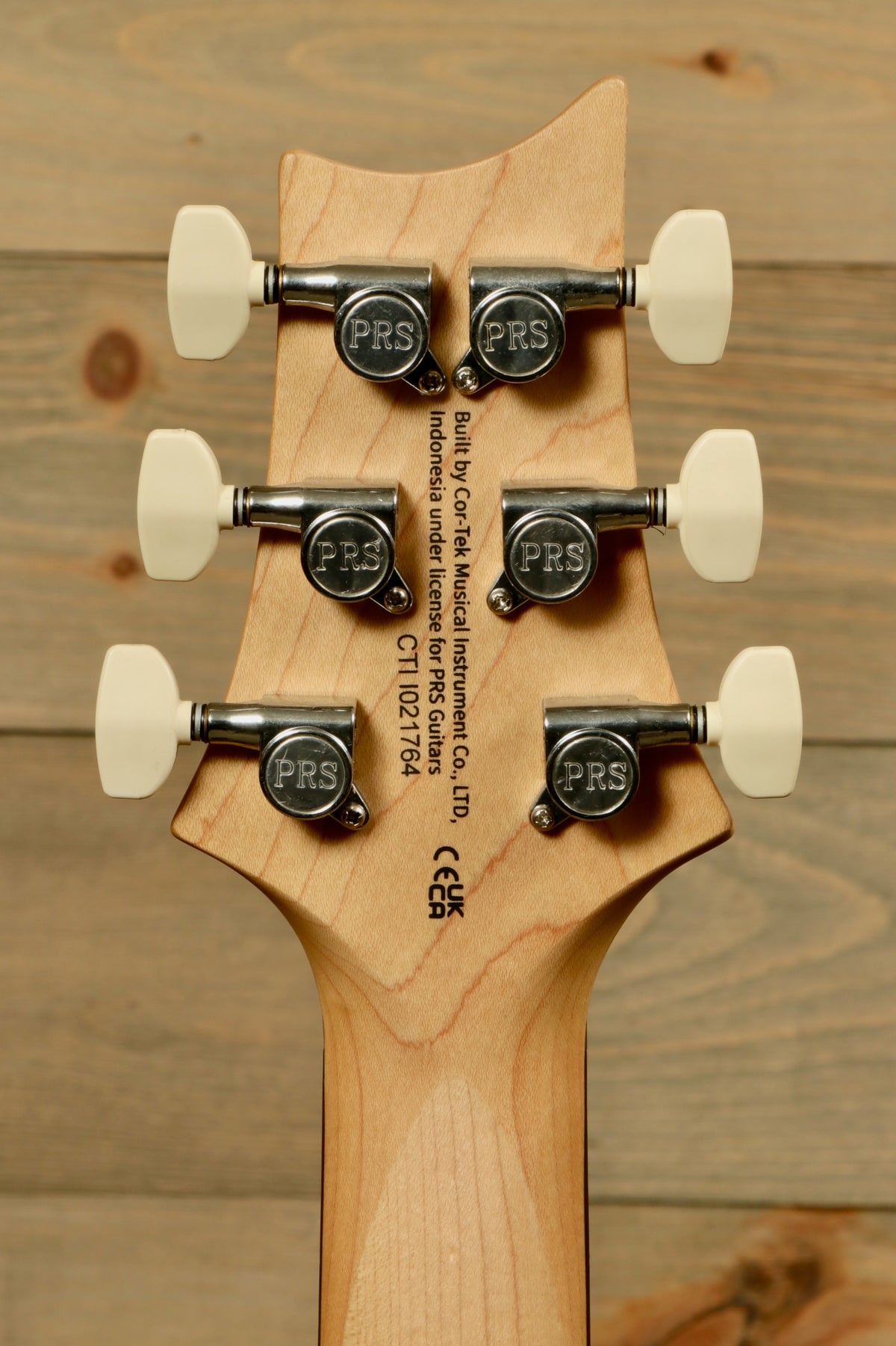 PRS electric guitar headstock, featuring six tuning pegs and logo detail
