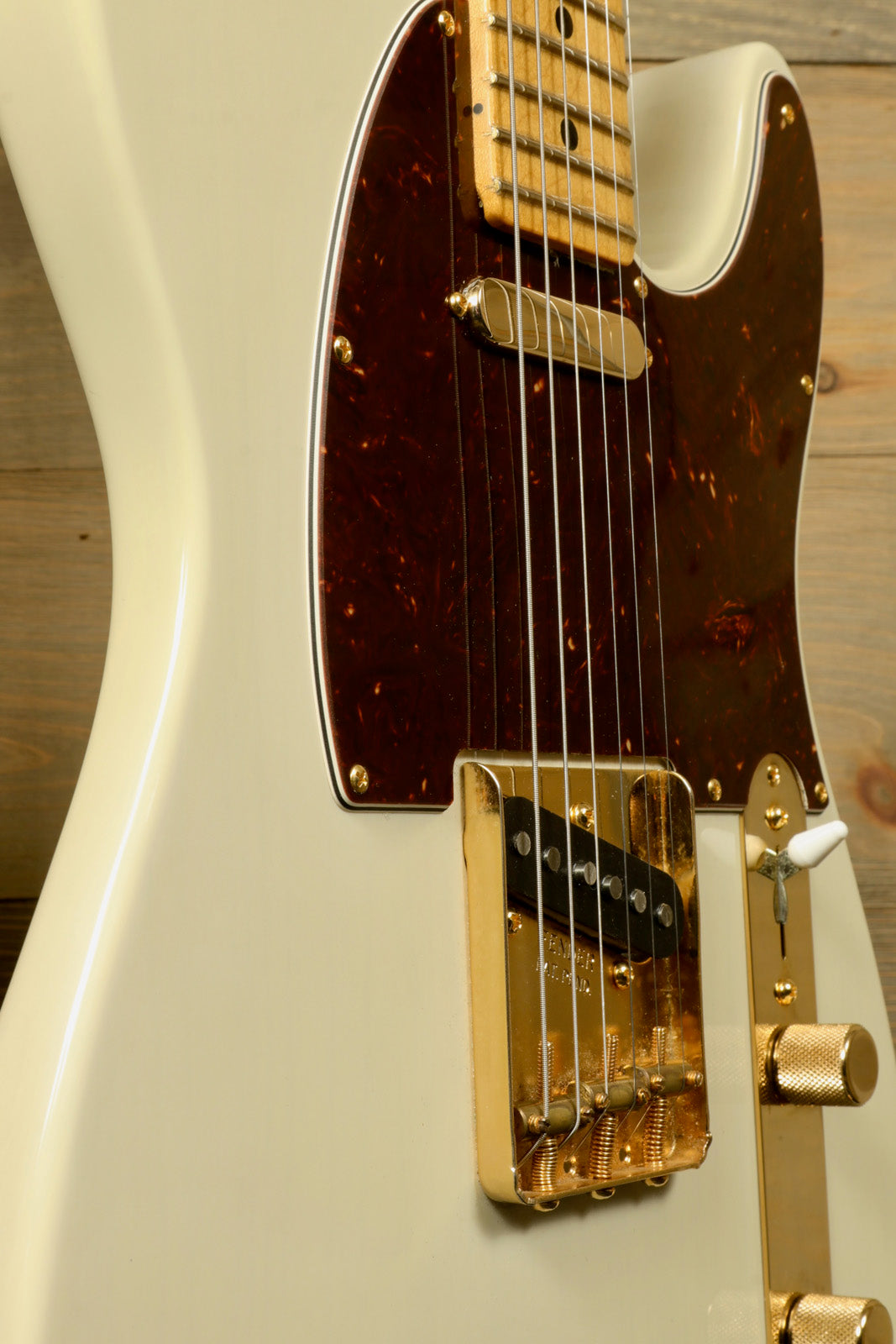 Fender Limited Edition Select Light Ash Telecaster in white with gold hardware, side view 