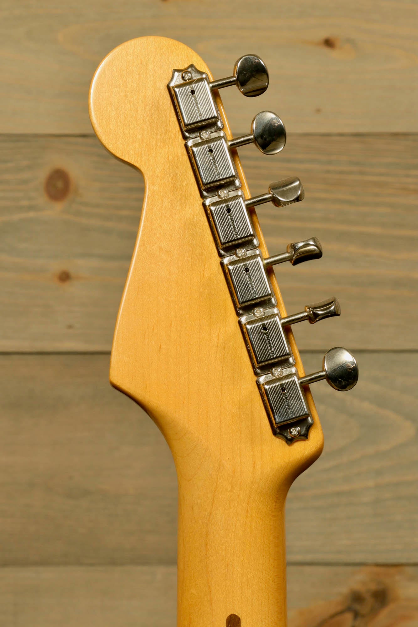 Fender Original 50's Strat with case showcasing the headstock and tuning pegs in detail