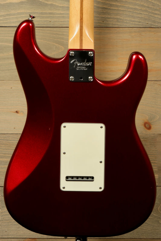 Back view of used Fender Stratocaster left handed guitar showcasing its glossy red finish