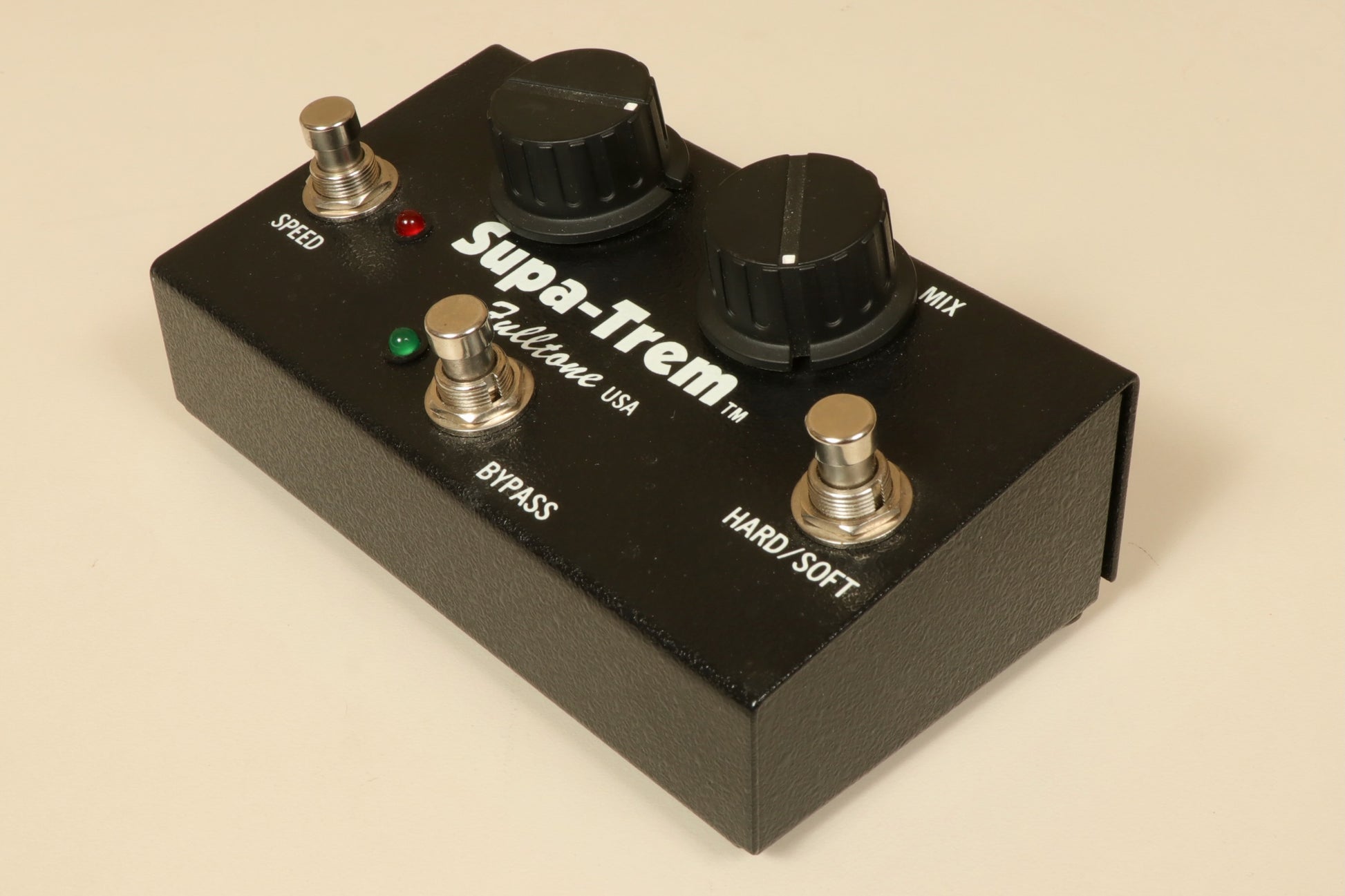 Fulltone SupaTrem black effects pedal, front view with knobs for speed and mix