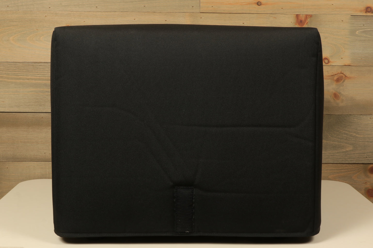 Genzler bass cabinet in black, front view with padded design for protection.