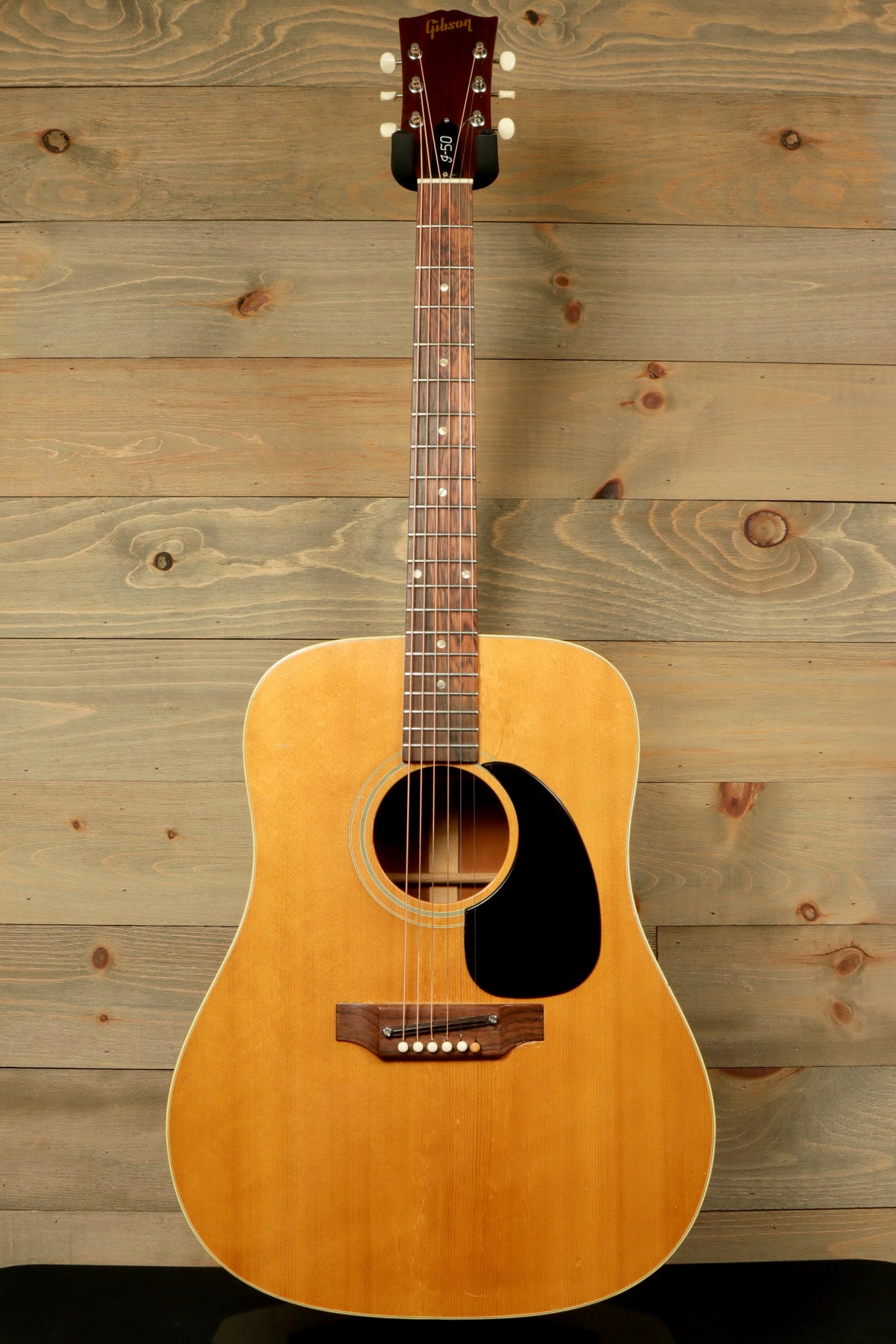 1968 Gibson J-50 Deluxe for sale, showcasing a natural finish and classic acoustic design.