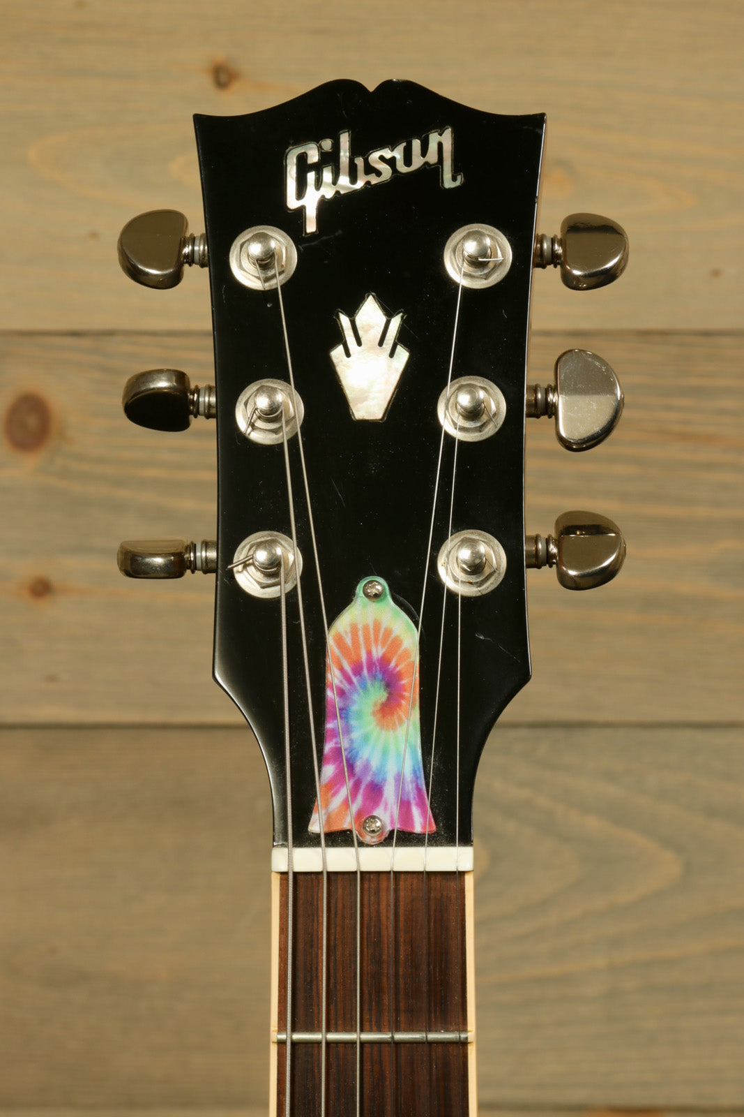 Gibson custom gibson es-335 headstock with tie-dye inlay, close-up view
