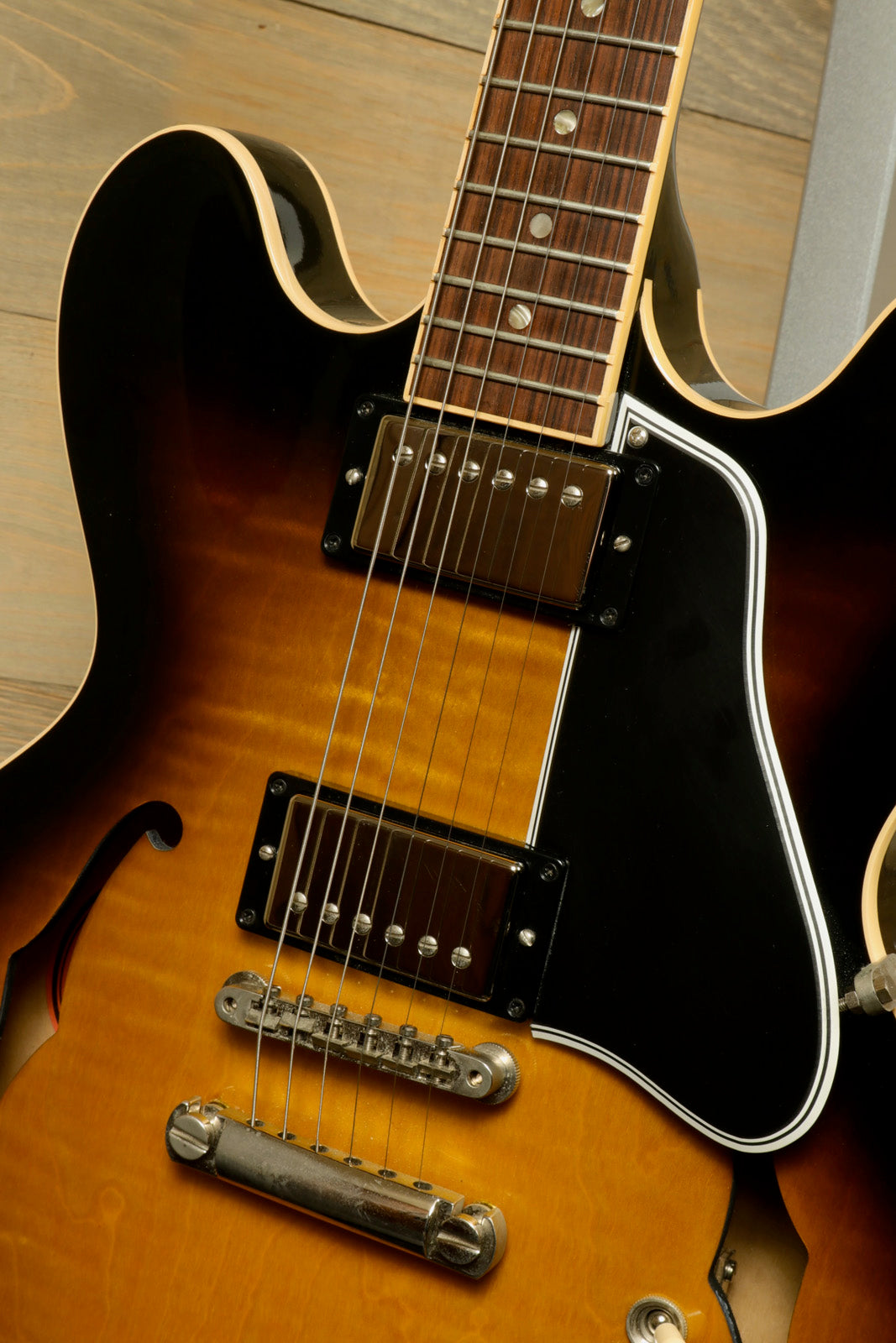 Gibson custom ES-335 hollow body electric guitar in sunburst finish, front view showcasing the neck and pickups