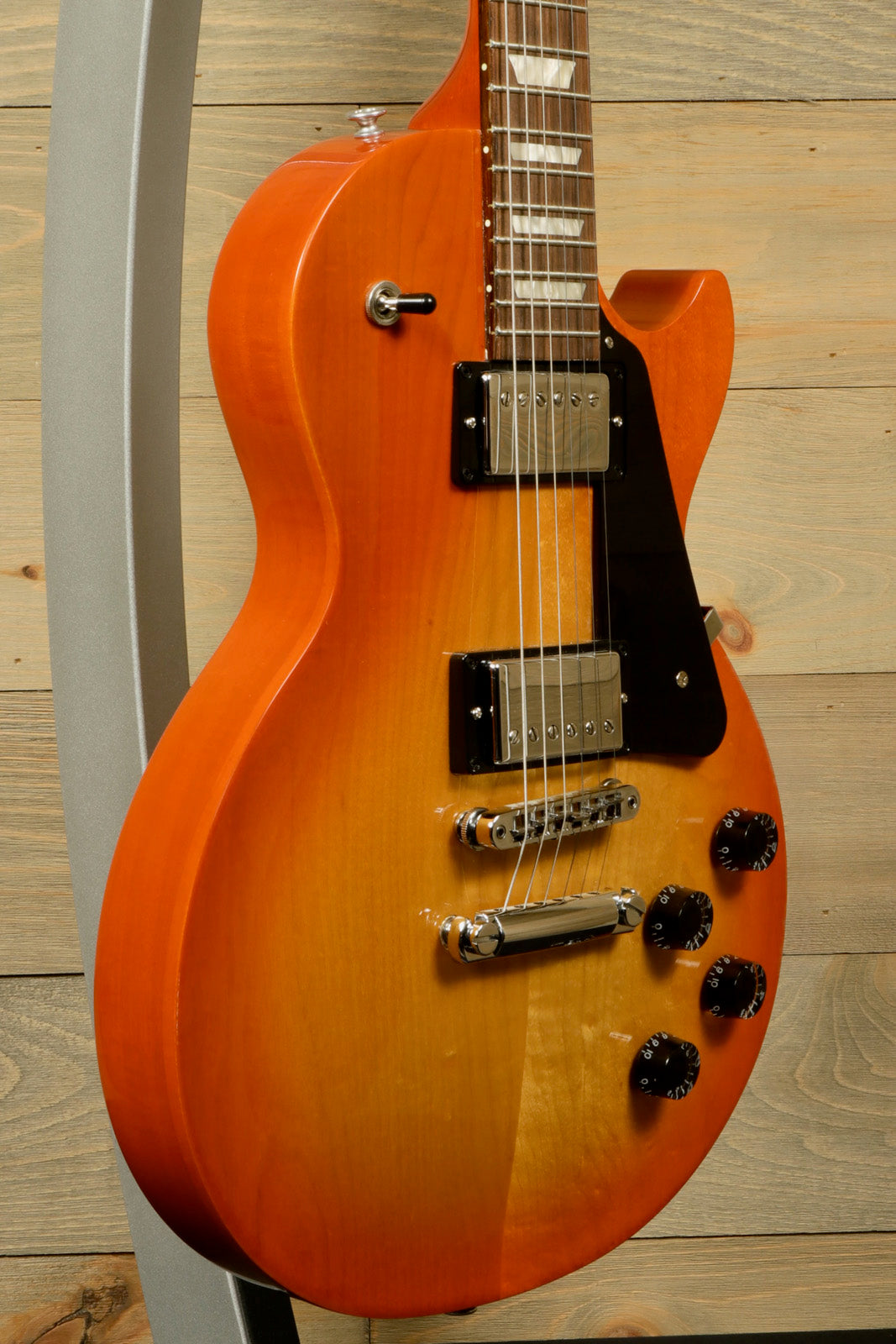 Gibson Les Paul Studio in sunburst finish, side view showcasing sleek curves and control layout