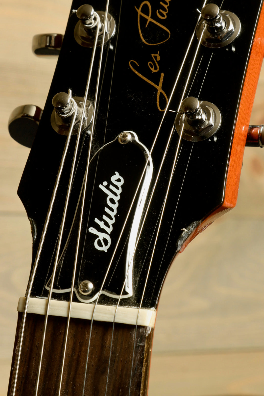 Gibson Les Paul Studio headstock in black with silver hardware and classic logo