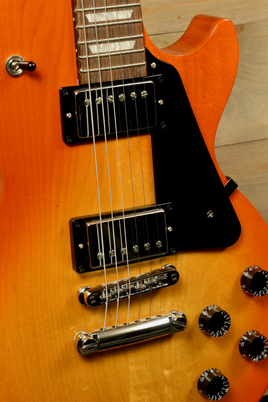 Gibson Les Paul Studio in sunburst finish, close-up view highlighting pickups and controls